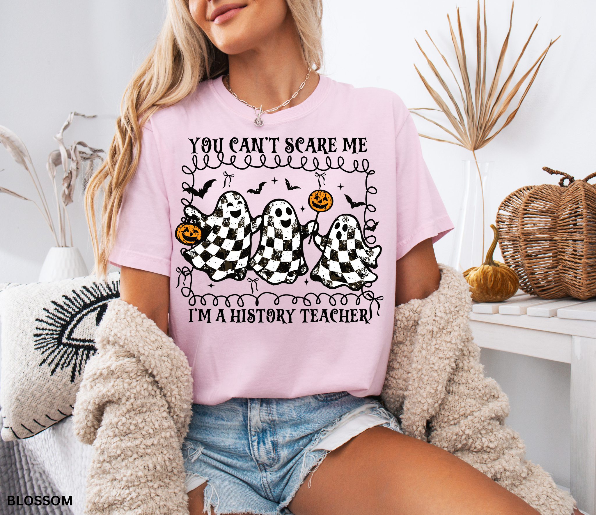 Halloween history teacher shirt with three distressed checkered ghosts holding pumpkins, surrounded by bats. Funny spooky social studies teacher tee.