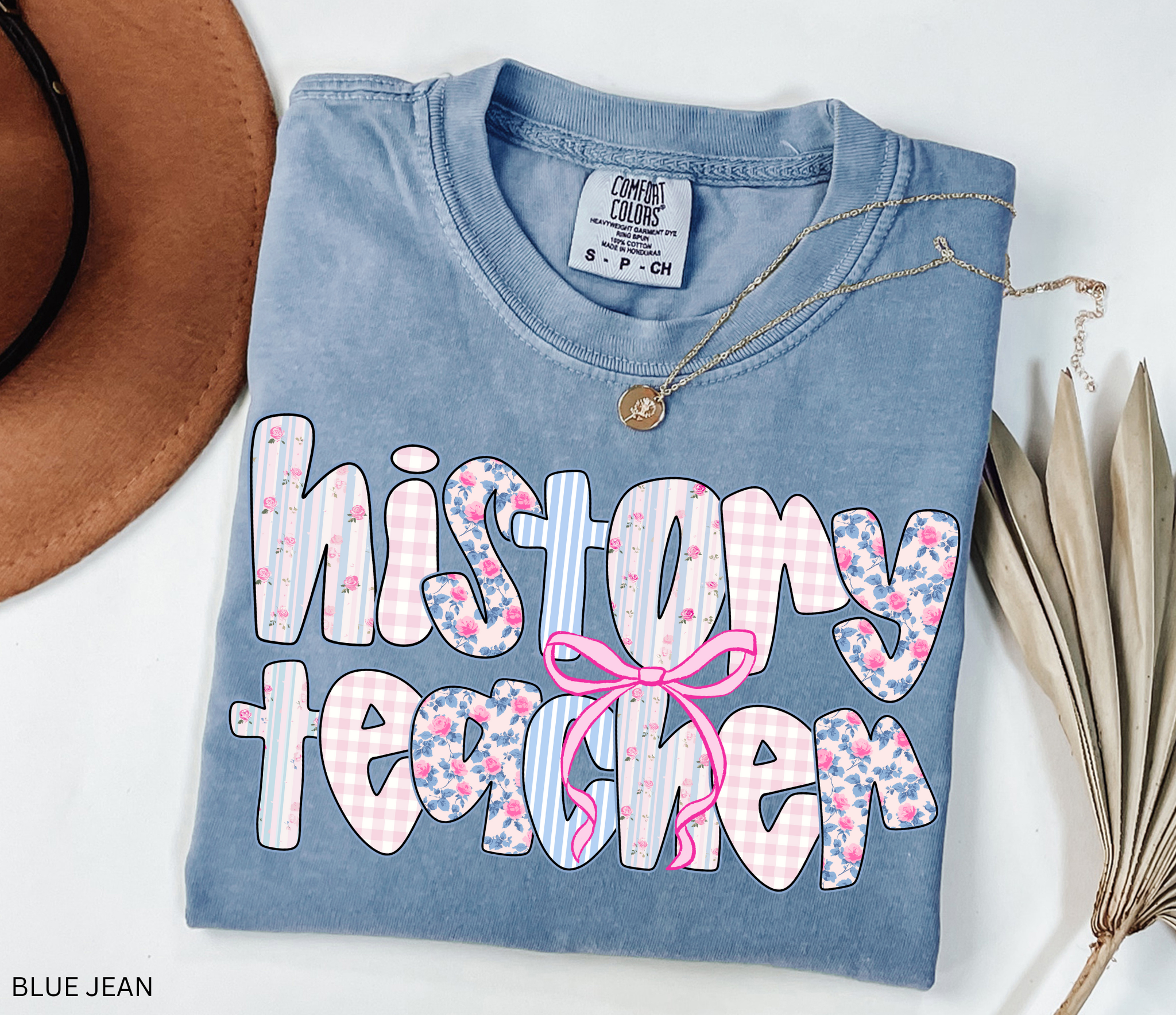 History teacher shirt with floral and gingham patchwork letters and a pink bow design. Cute and aesthetic retro-style teacher tee