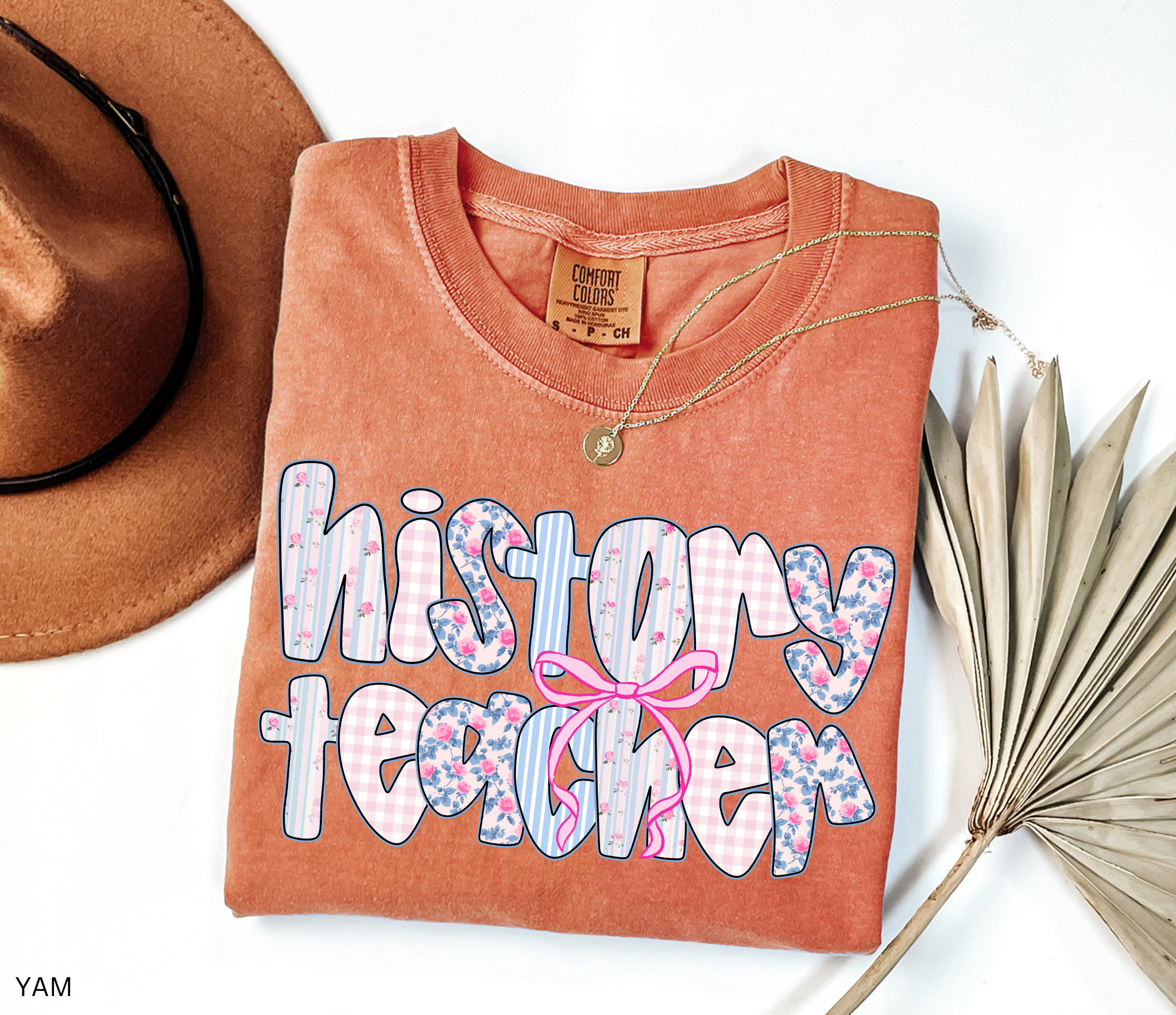 History teacher shirt with floral and gingham patchwork letters and a pink bow design. Cute and aesthetic retro-style teacher tee
