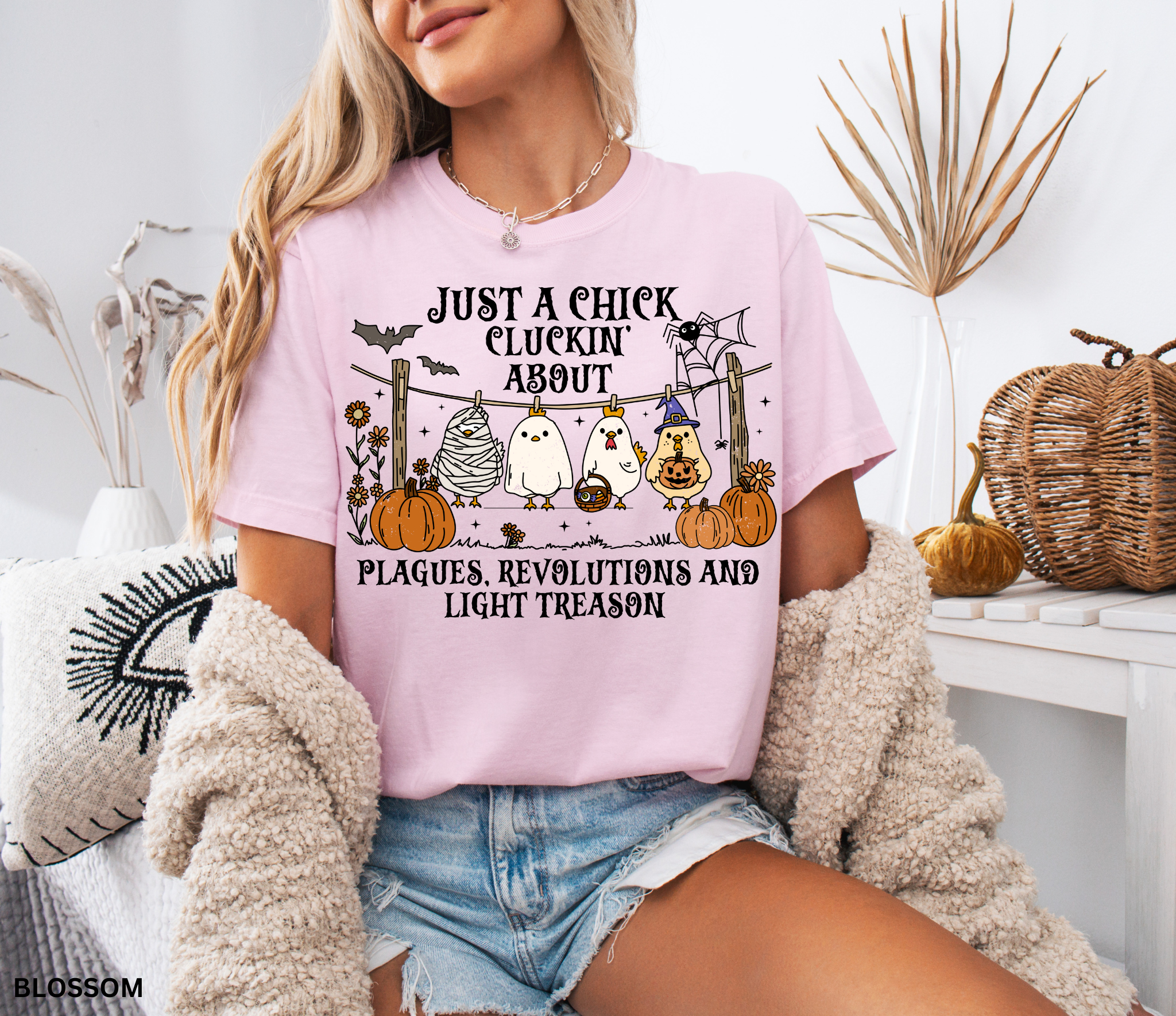 Halloween history teacher shirt with chickens in costumes, pumpkins, and text that reads ‘Just a chick cluckin’ about plagues, revolutions, and light treason.’ Funny spooky teacher tee