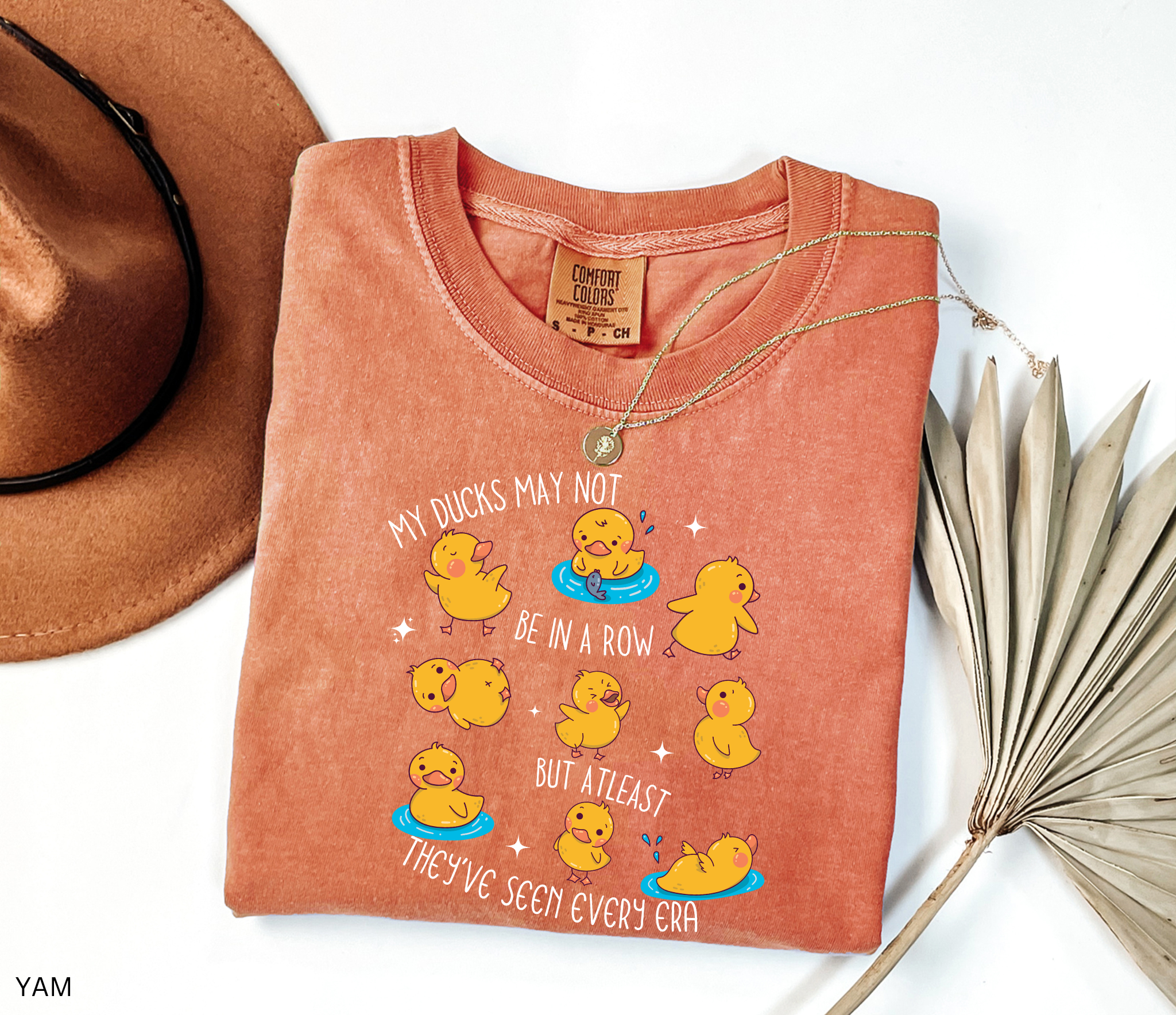 Cute history teacher shirt design with cartoon yellow ducks in different poses and the phrase “My ducks may not be in a row but at least they’ve seen every era.” Funny gift for history and social studies teachers.