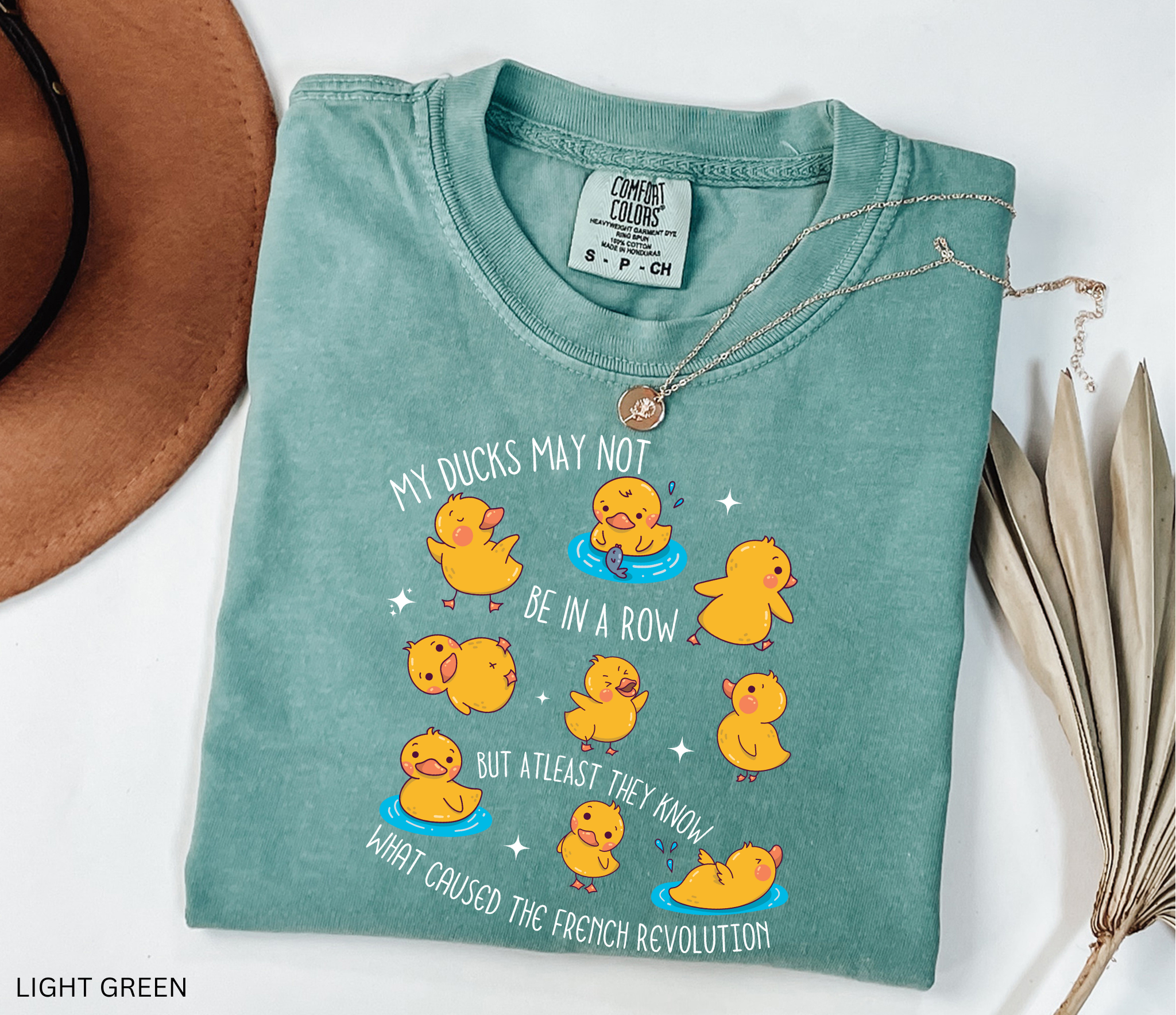 playful yellow ducks and the phrase “My ducks may not be in a row, but at least they know what caused the French Revolution.” Funny gift for history and social studies teachers.