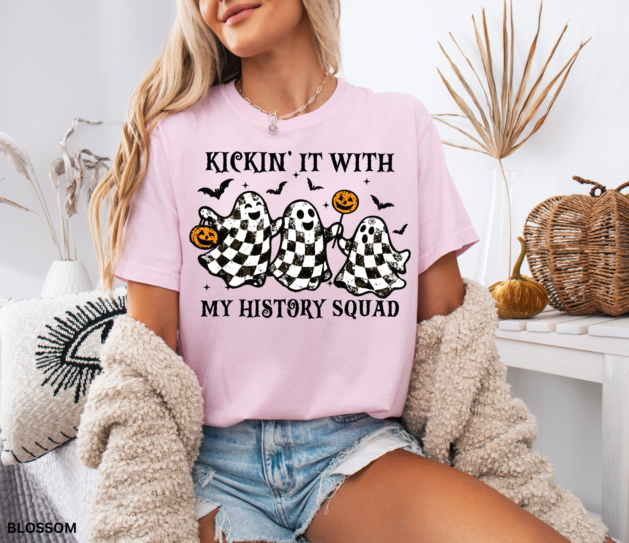 Halloween history teacher shirt with distressed checkered ghosts holding pumpkins and candy, surrounded by bats. Funny and spooky teacher design.