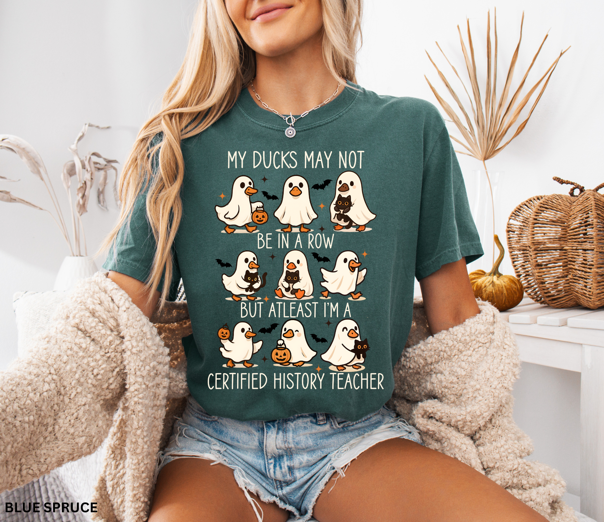 Halloween shirt design with ghost ducks carrying pumpkins and black cats, paired with the phrase “certified history teacher.”