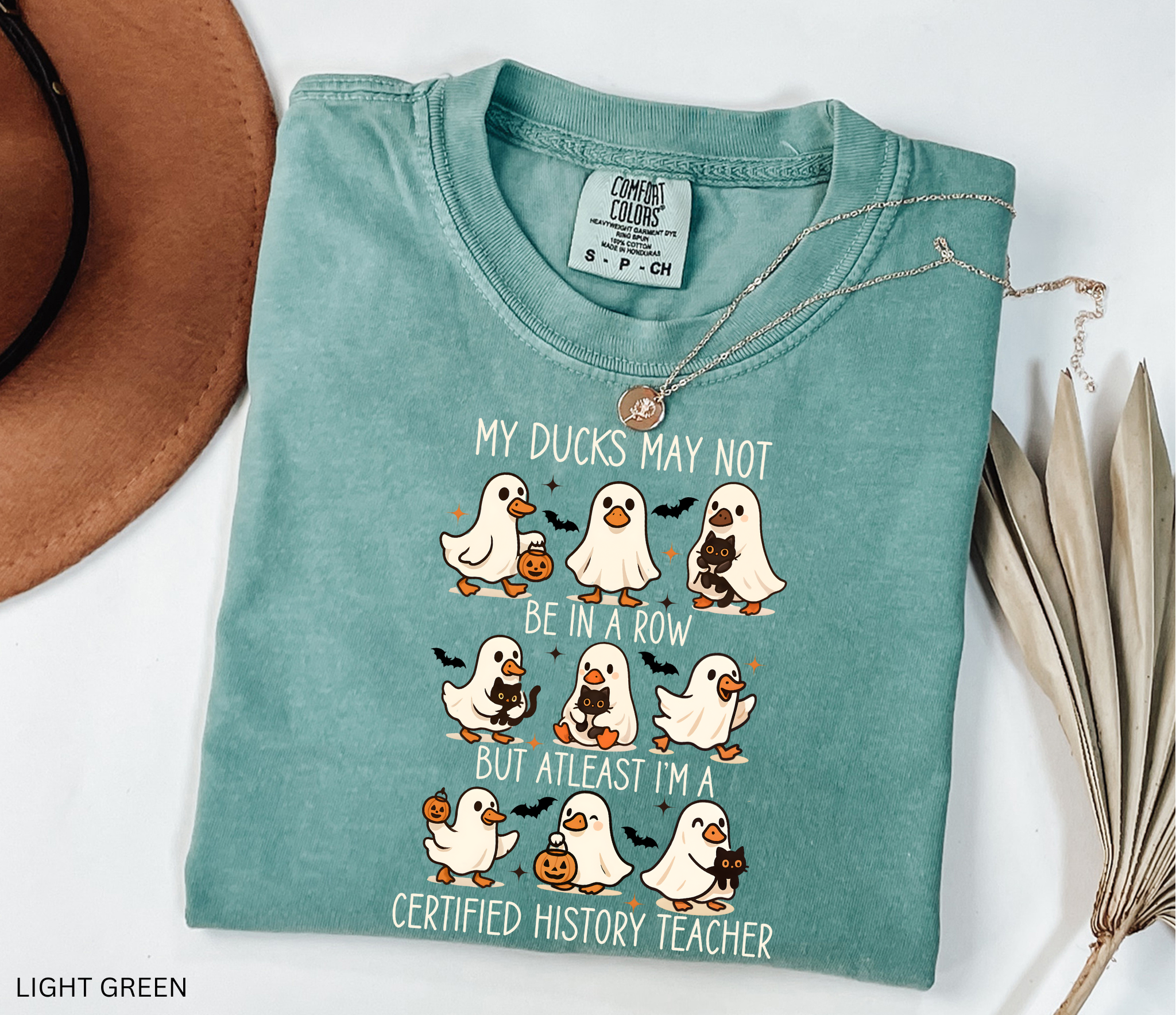 Halloween shirt design with ghost ducks carrying pumpkins and black cats, paired with the phrase “certified history teacher.”