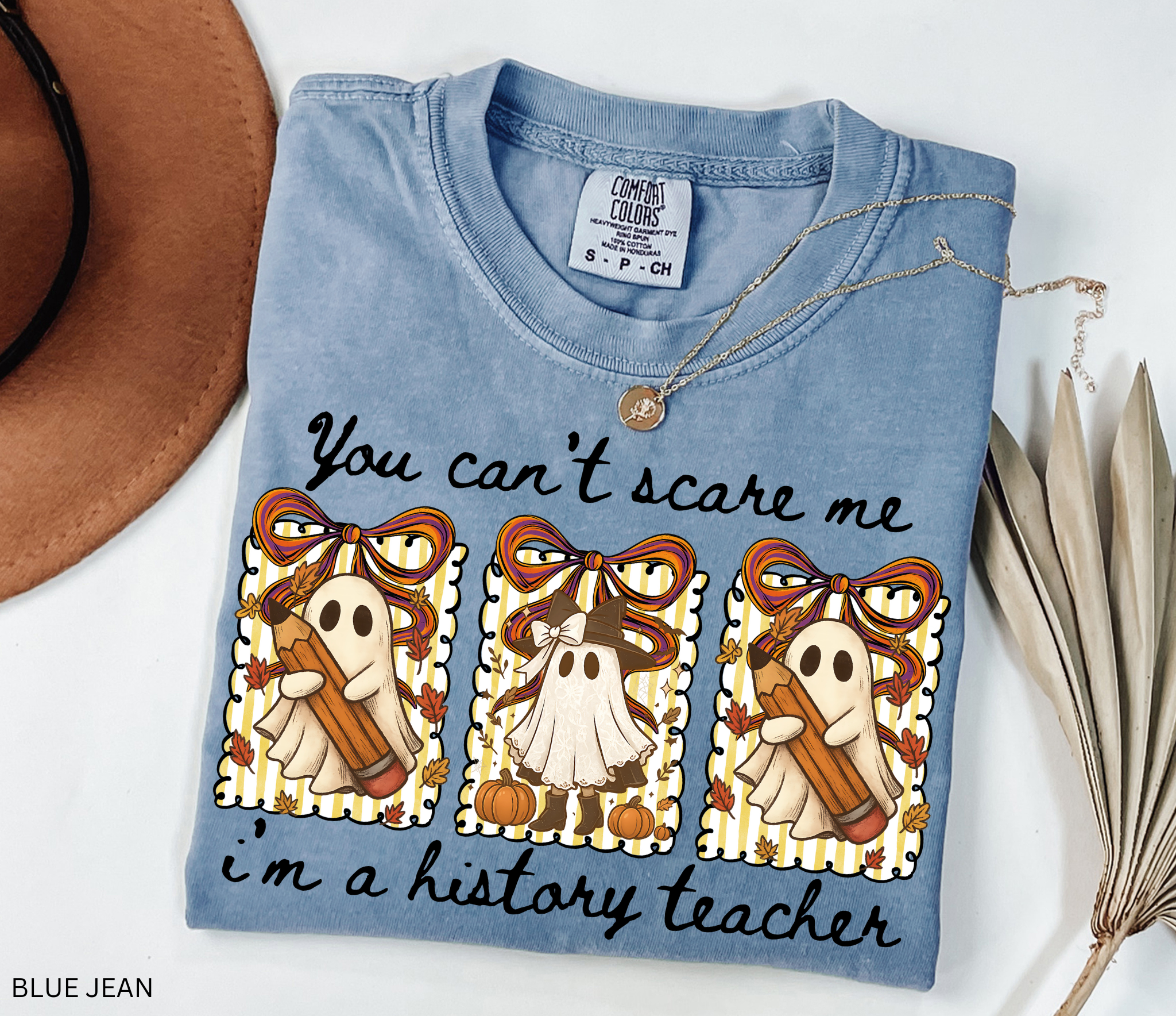 Halloween shirt design with three patchwork ghosts holding pencils and pumpkins, decorated with bows, leaves, and autumn stripes.