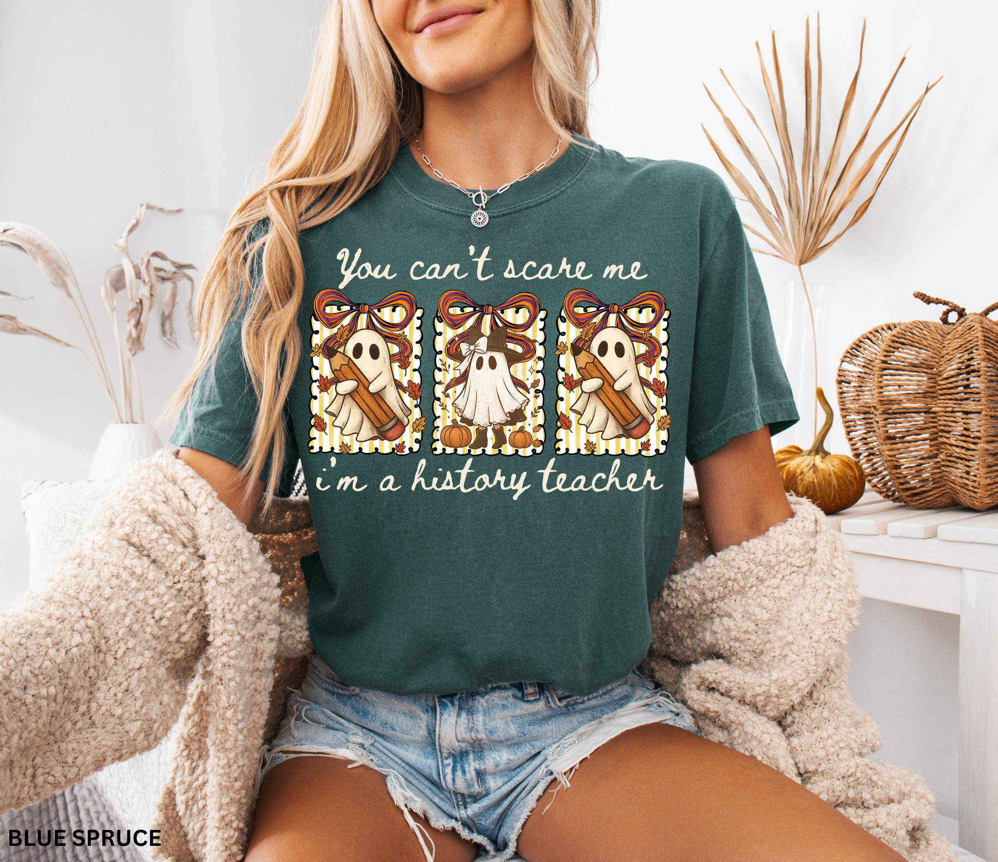 Halloween shirt design with three patchwork ghosts holding pencils and pumpkins, decorated with bows, leaves, and autumn stripes.
