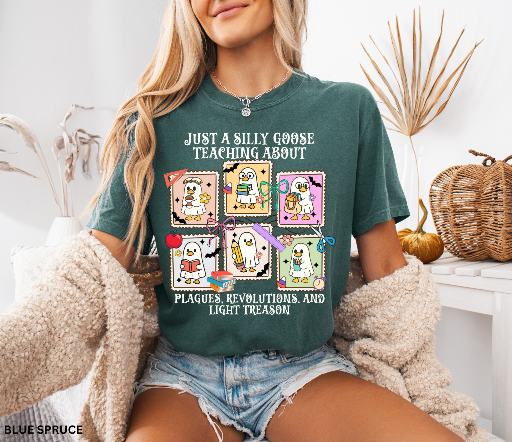 Halloween shirt design with cartoon geese dressed as teachers holding books, pencils, and coffee, surrounded by bats, pumpkins, and school supplies.