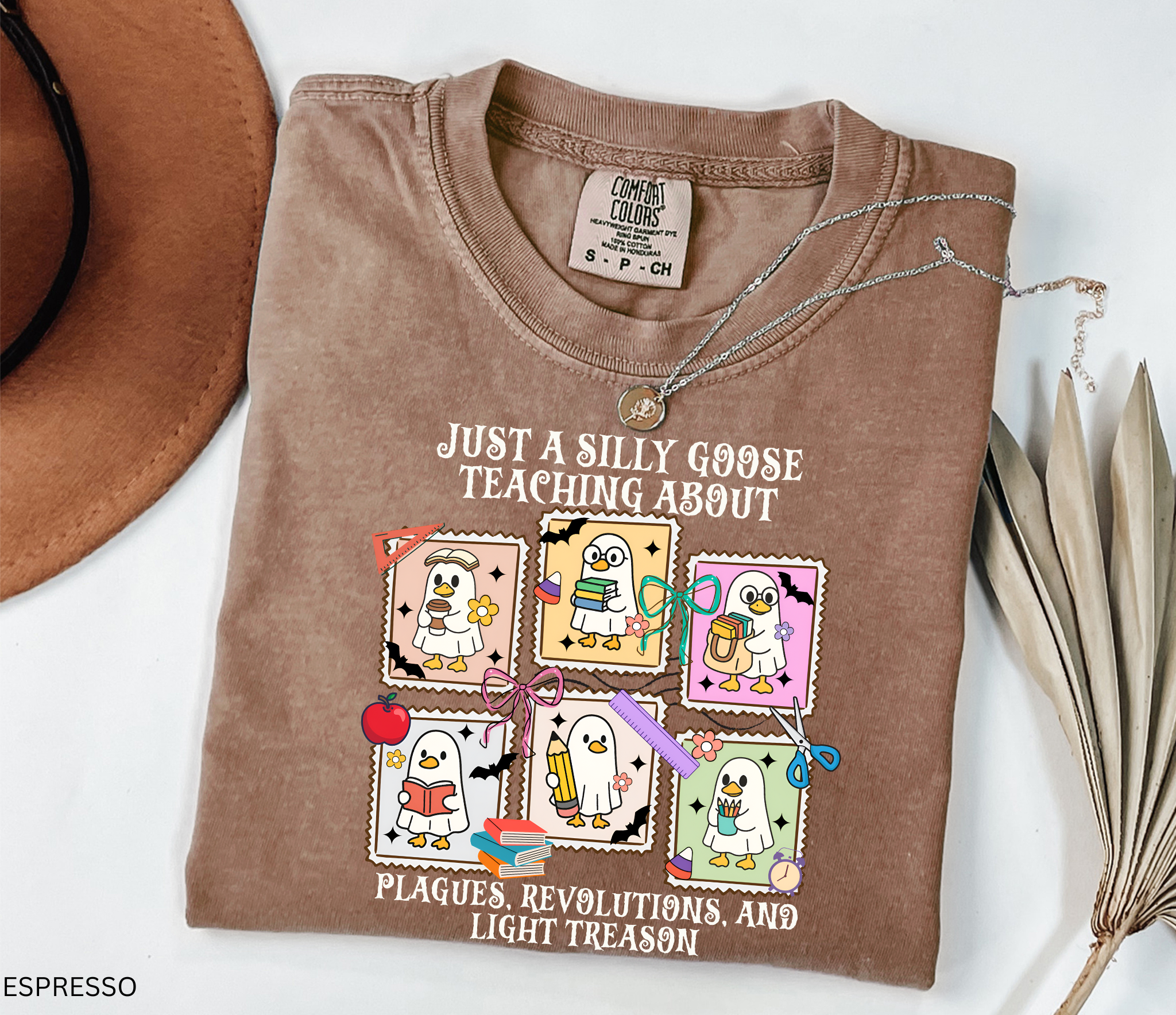 Halloween shirt design with cartoon geese dressed as teachers holding books, pencils, and coffee, surrounded by bats, pumpkins, and school supplies.