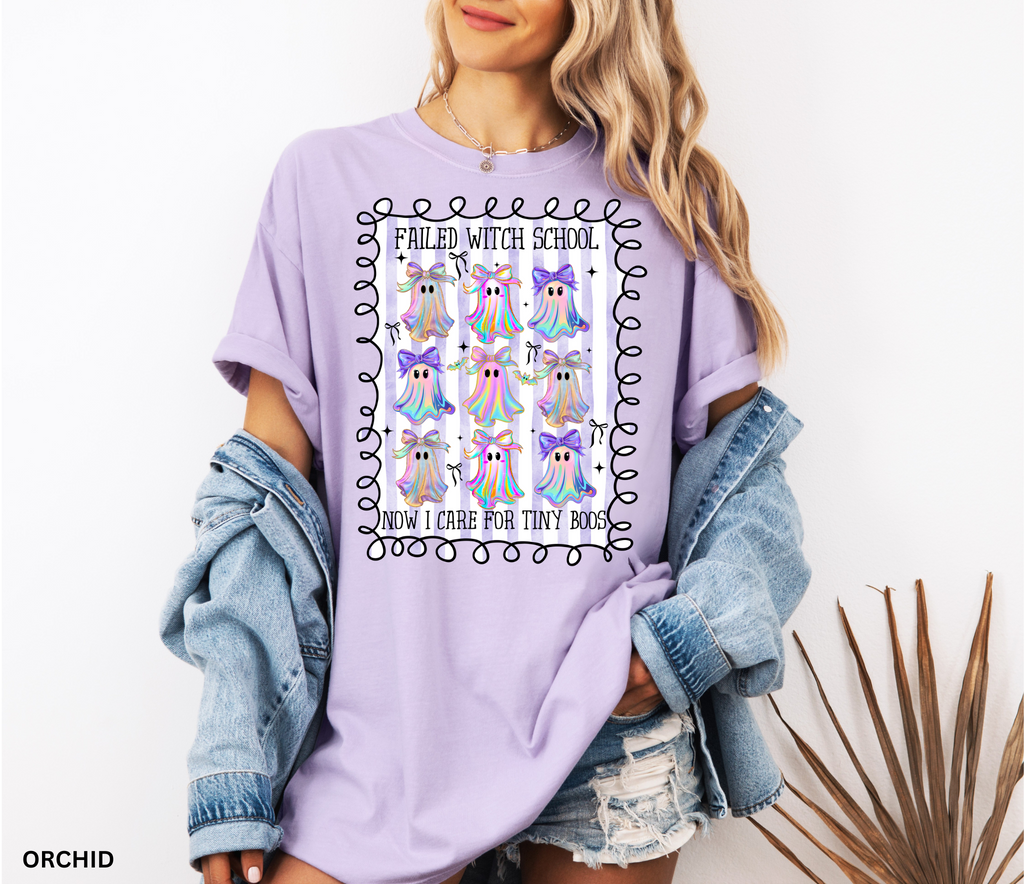 Daycare teacher Halloween shirt with colorful rainbow ghosts and bows, featuring the phrase “Failed Witch School, Now I Care for Tiny Boos.” Funny Halloween tee for childcare workers.