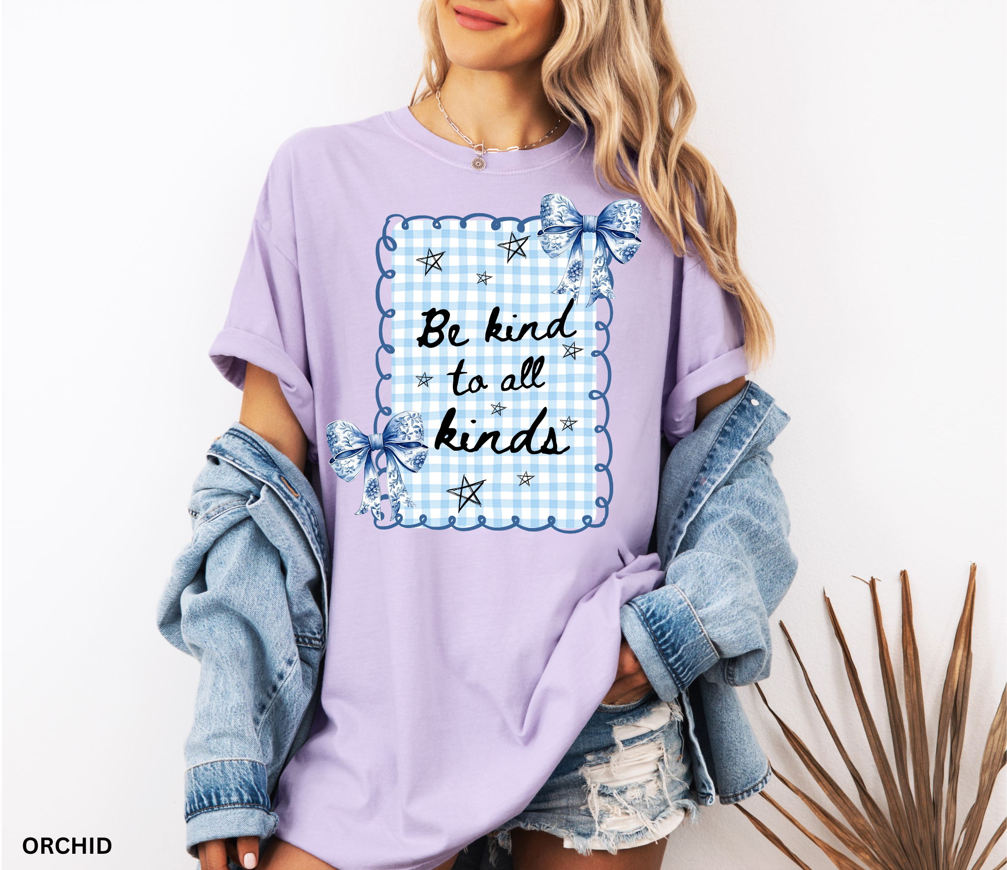 Blue gingham “Be Kind to All Kinds” shirt with bows and stars – kindness graphic tee for teachers and educators.