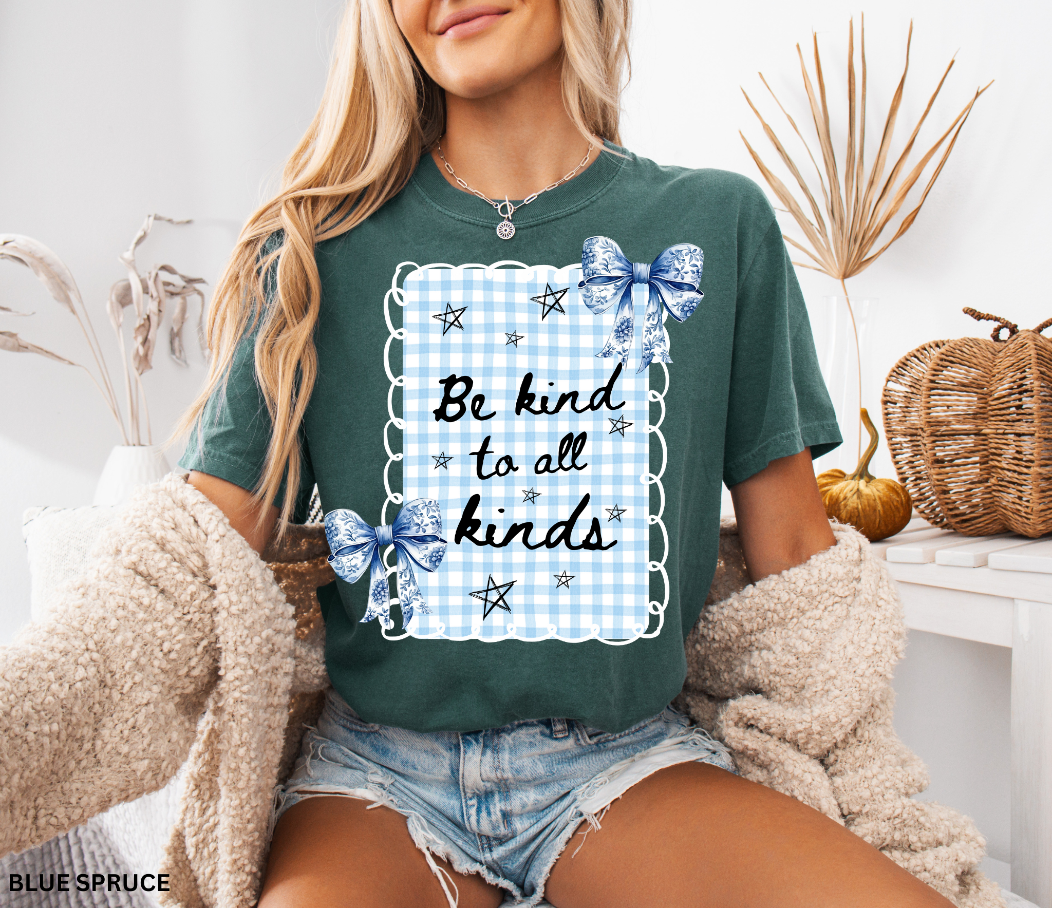 Blue gingham “Be Kind to All Kinds” shirt with bows and stars – kindness graphic tee for teachers and educators.