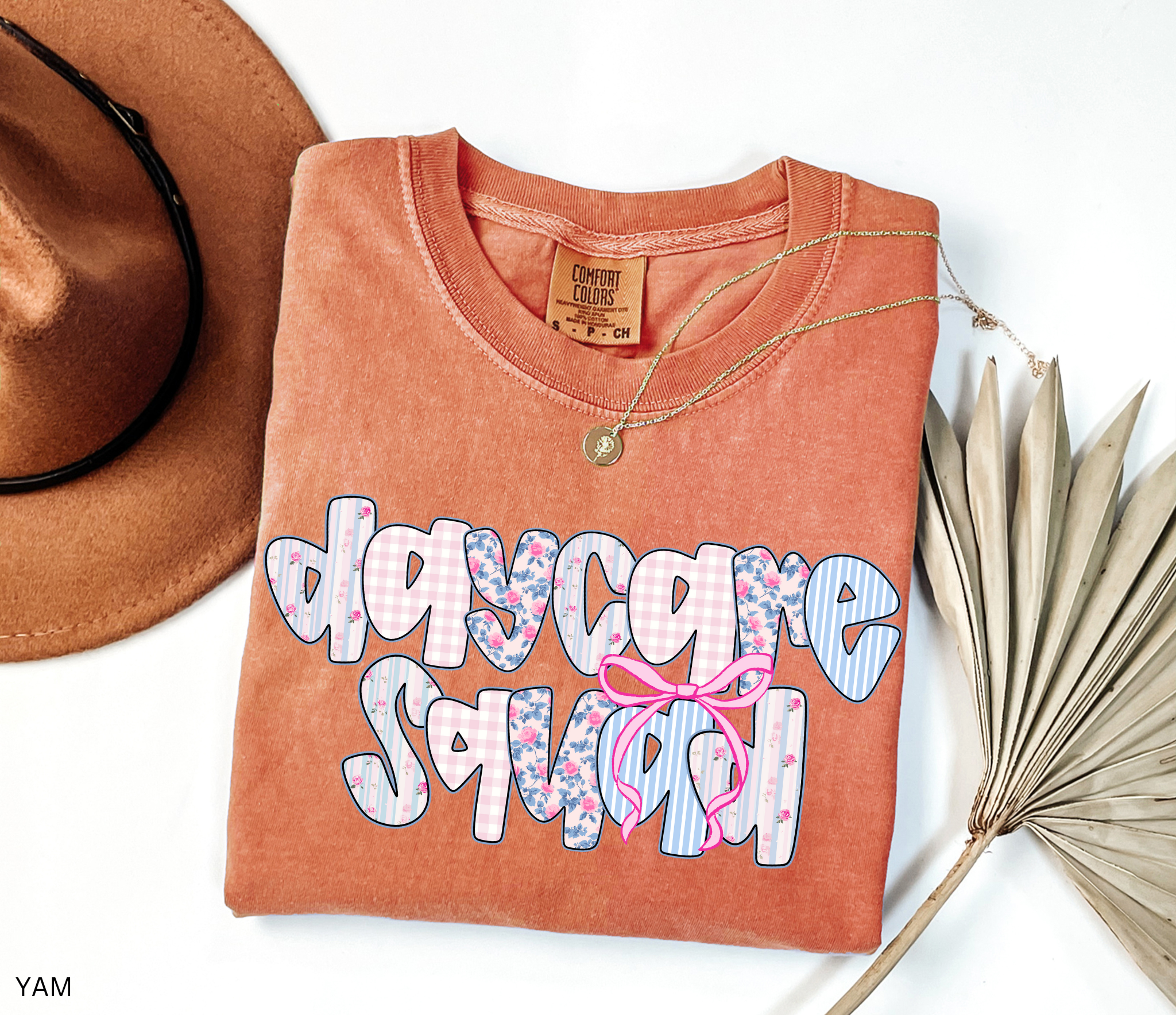 Daycare Squad shirt with floral patterns and pink bow design – teacher team apparel