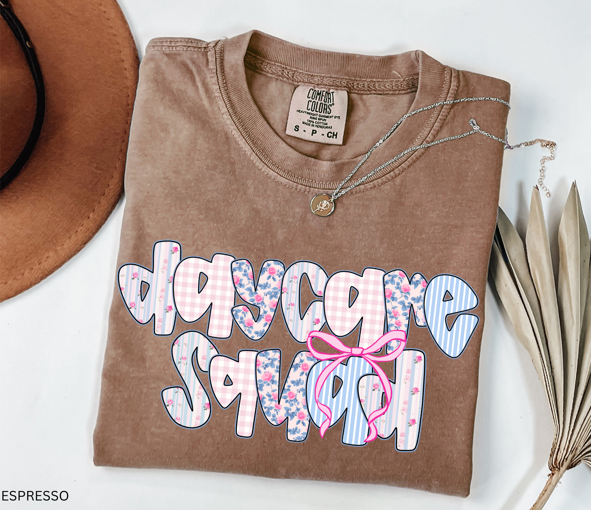 Daycare Squad shirt with floral patterns and pink bow design – teacher team apparel