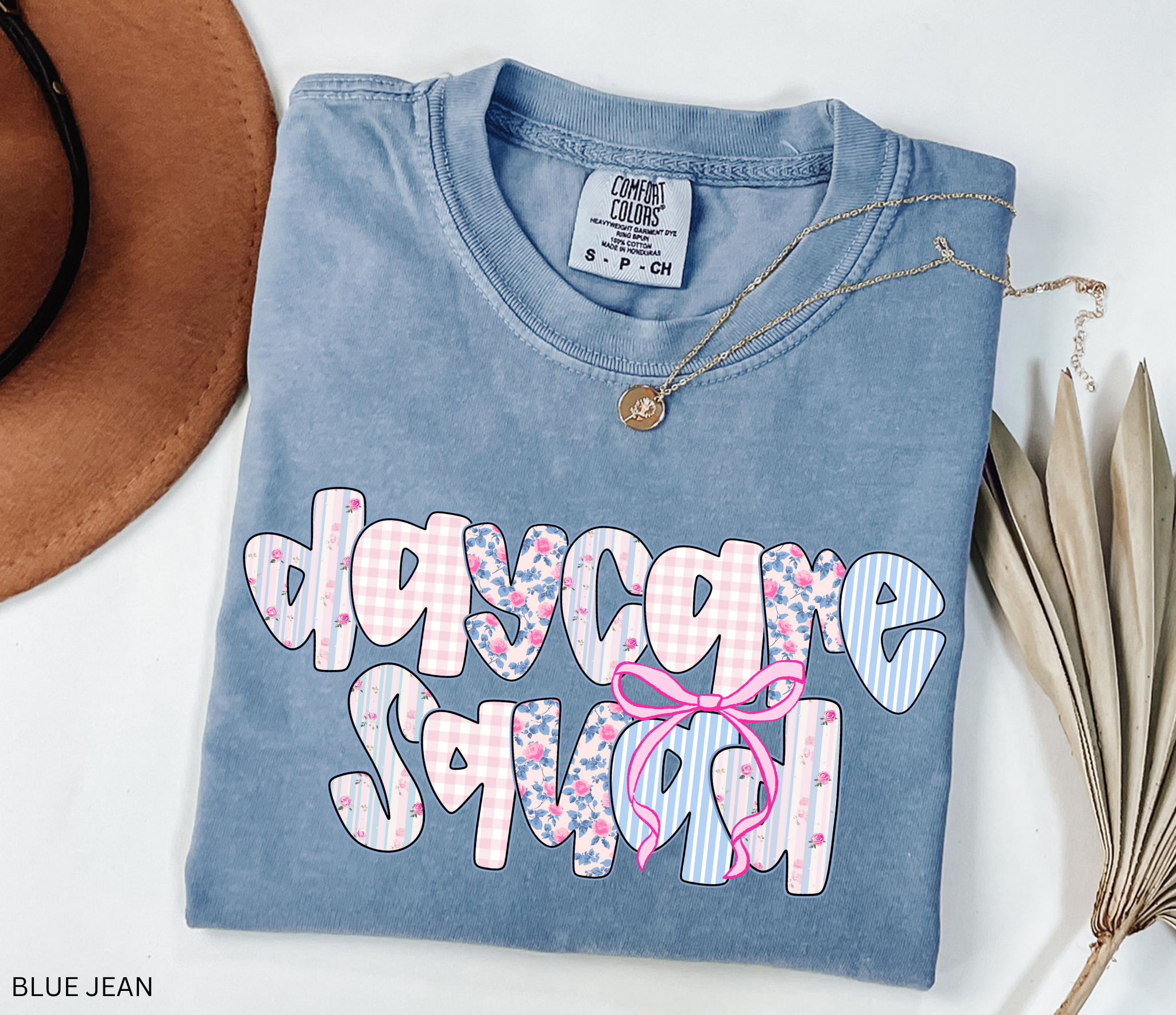 Daycare Squad shirt with floral patterns and pink bow design – teacher team apparel