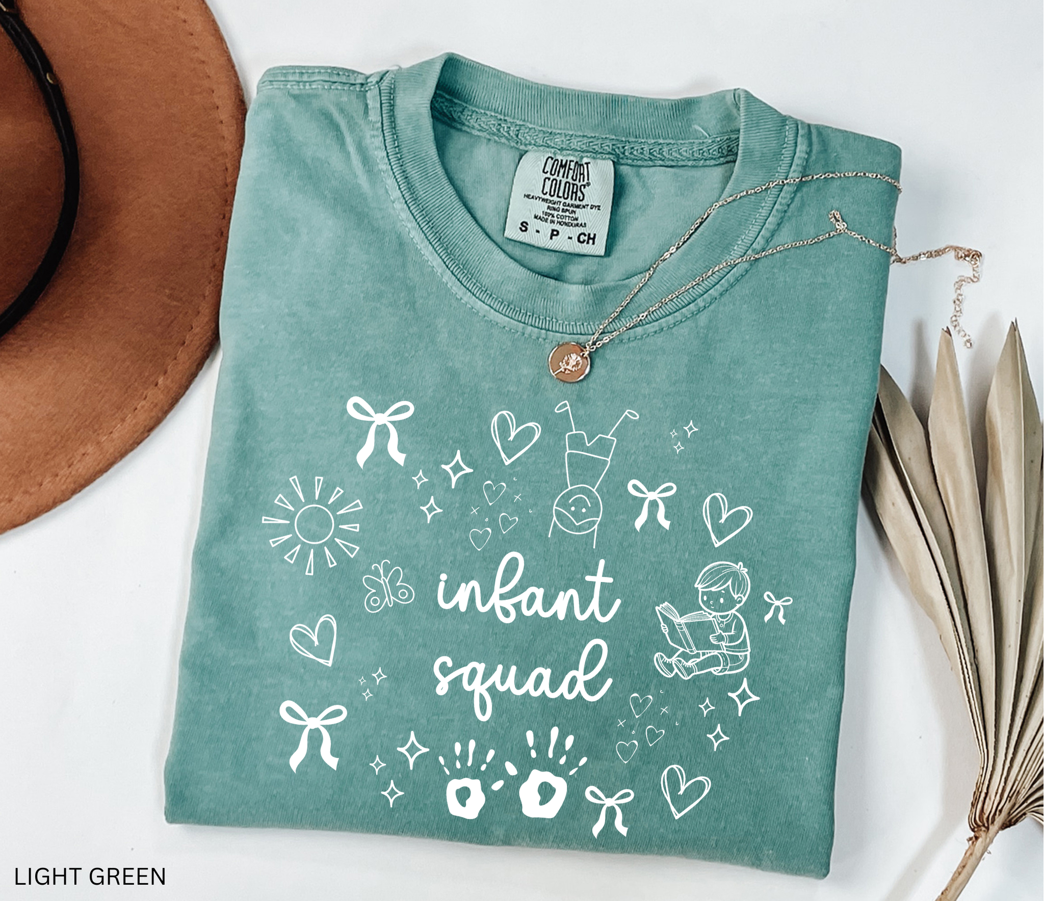 White doodle-style design with bows, hearts, stars, sunshine, baby handprints, a reading child, and the words “Infant Squad.”
