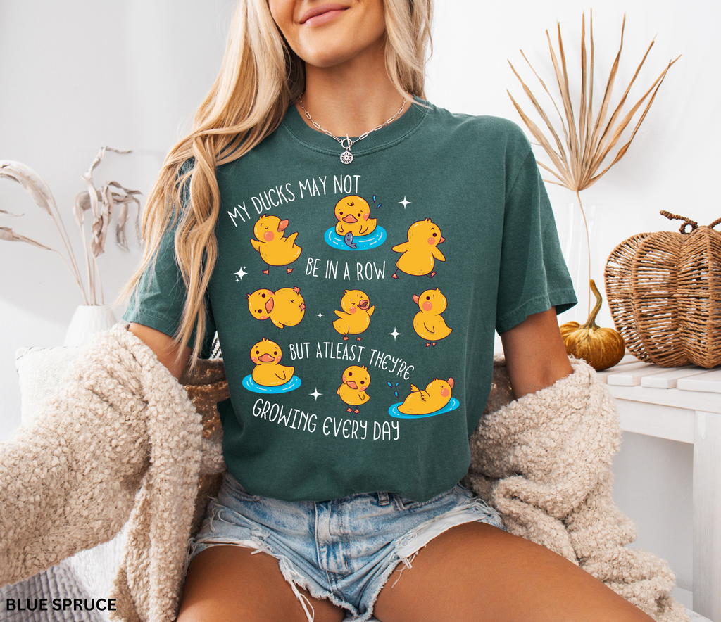 Daycare teacher shirt with cartoon ducklings and the phrase My ducks may not be in a row but at least they’re growing every day