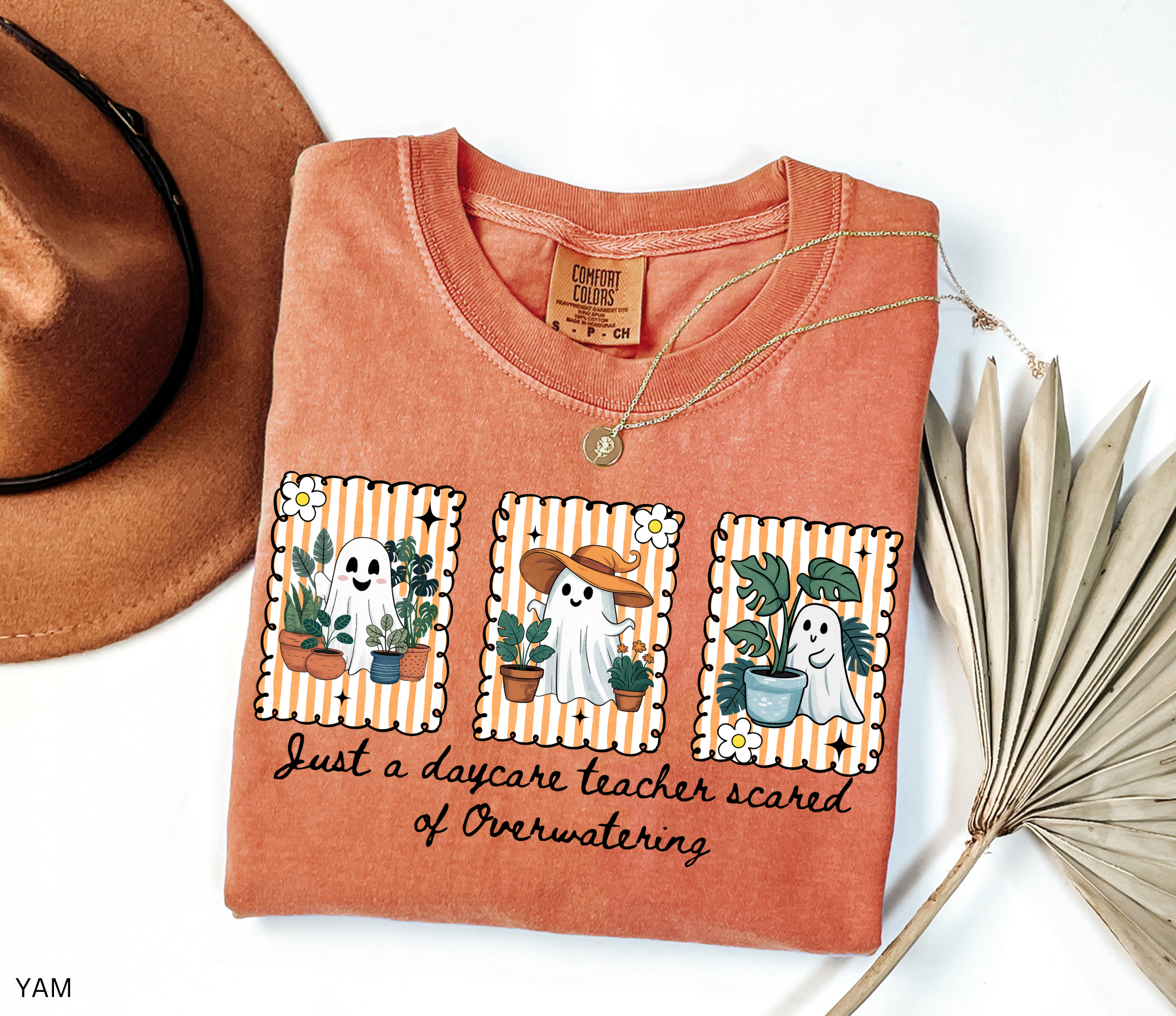 Daycare teacher Halloween shirt with three cute ghosts surrounded by plants and the phrase Just a daycare teacher scared of overwatering.