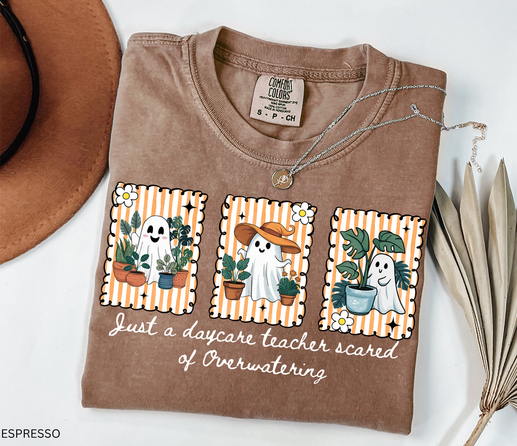 Daycare teacher Halloween shirt with three cute ghosts surrounded by plants and the phrase Just a daycare teacher scared of overwatering.
