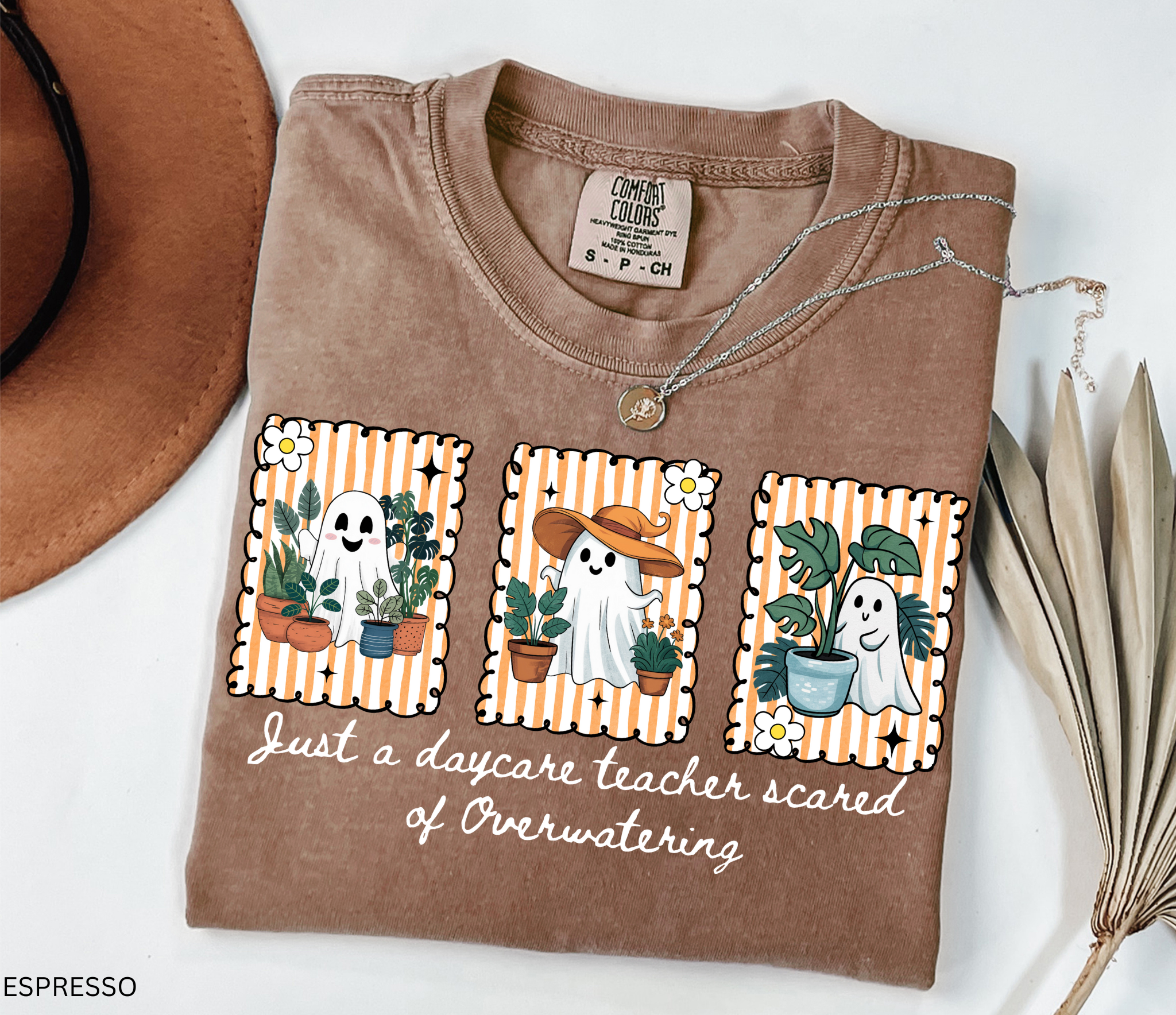 Daycare teacher Halloween shirt with three cute ghosts surrounded by plants and the phrase Just a daycare teacher scared of overwatering.