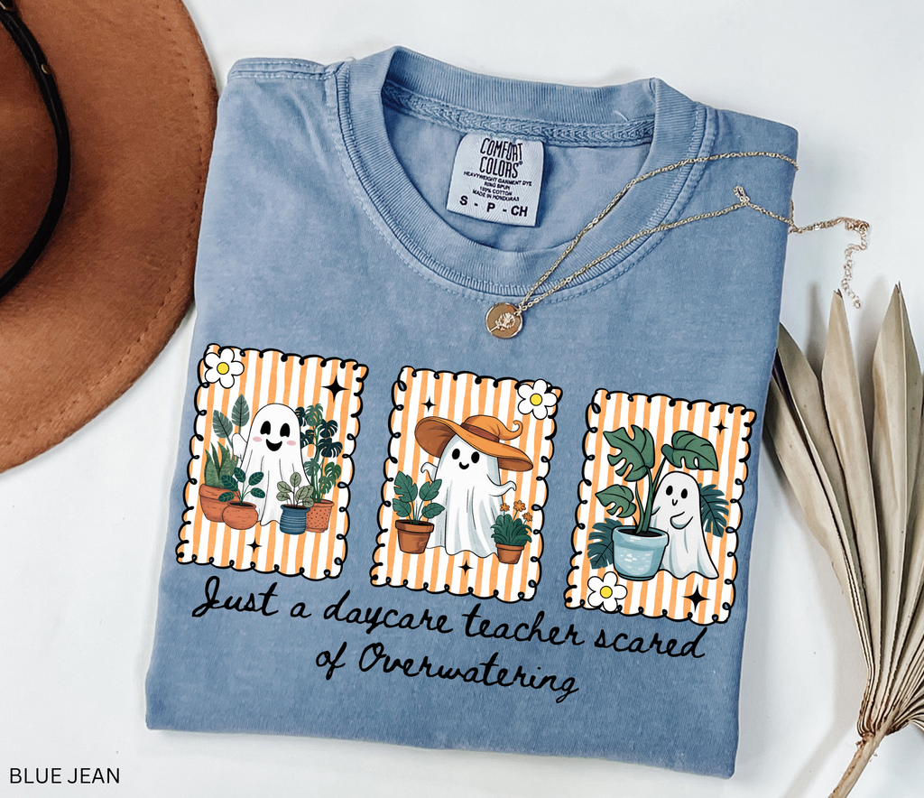 Daycare teacher Halloween shirt with three cute ghosts surrounded by plants and the phrase Just a daycare teacher scared of overwatering.