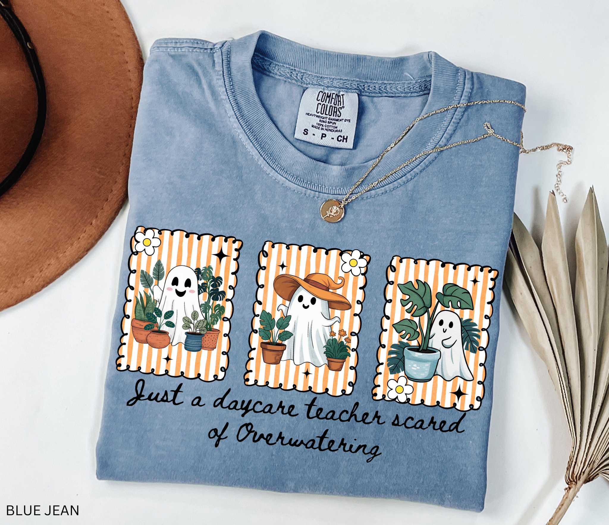 Daycare teacher Halloween shirt with three cute ghosts surrounded by plants and the phrase Just a daycare teacher scared of overwatering.