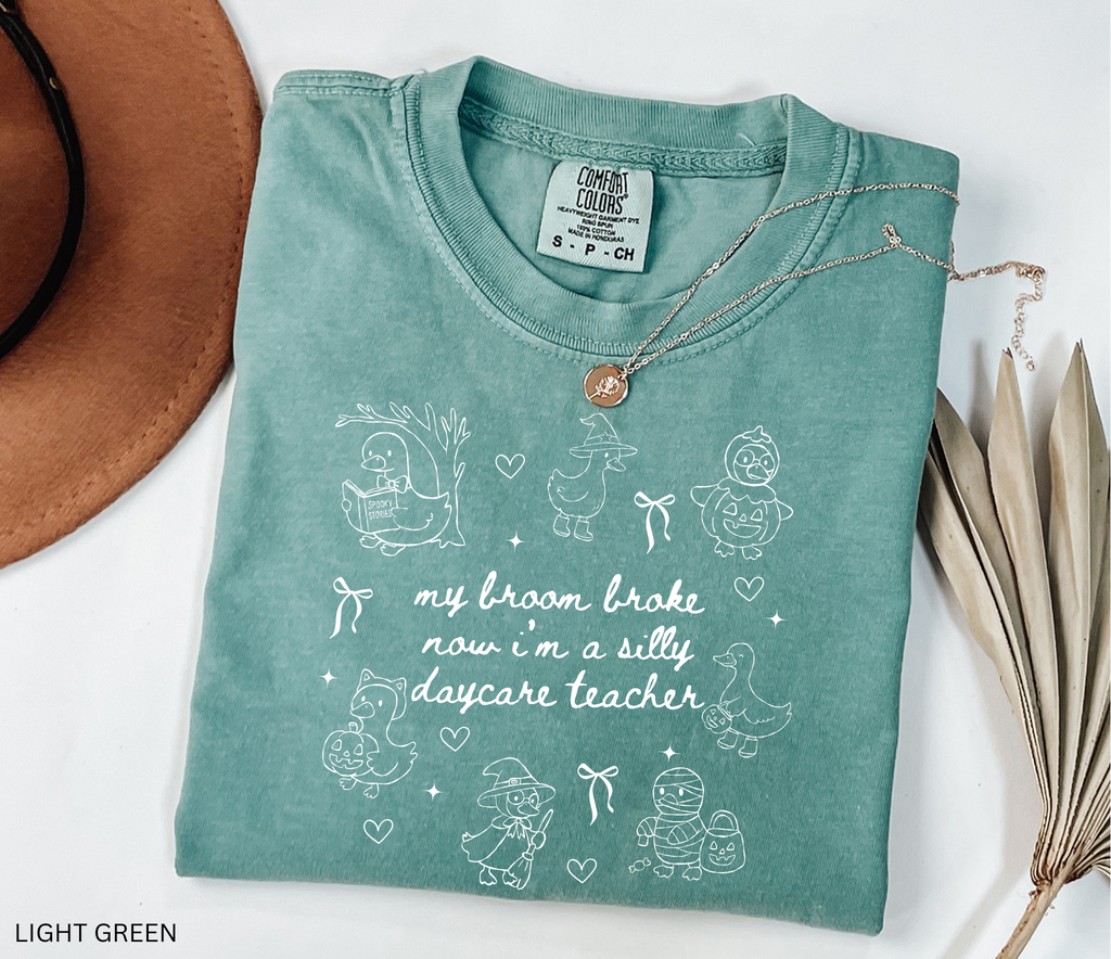 Halloween daycare teacher shirt with geese in witch, pumpkin, and mummy costumes with text saying My Broom Broke, Now I’m a Silly Daycare Teacher.
