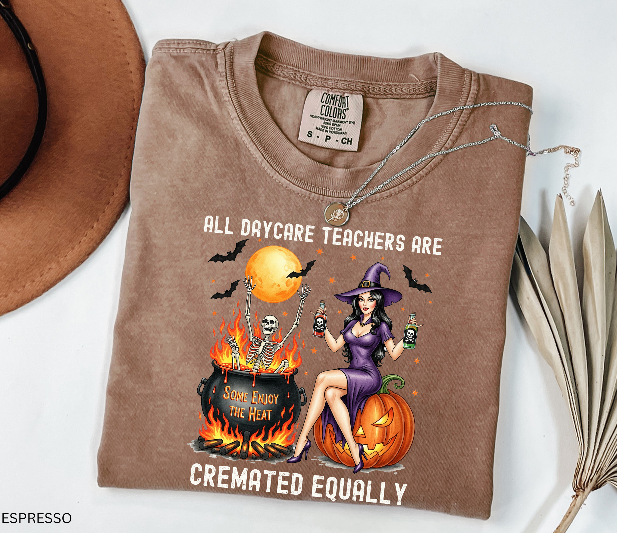 Halloween shirt design featuring a witch in a purple dress sitting on a pumpkin, holding potion bottles, with a skeleton in a fiery cauldron under a full moon.
