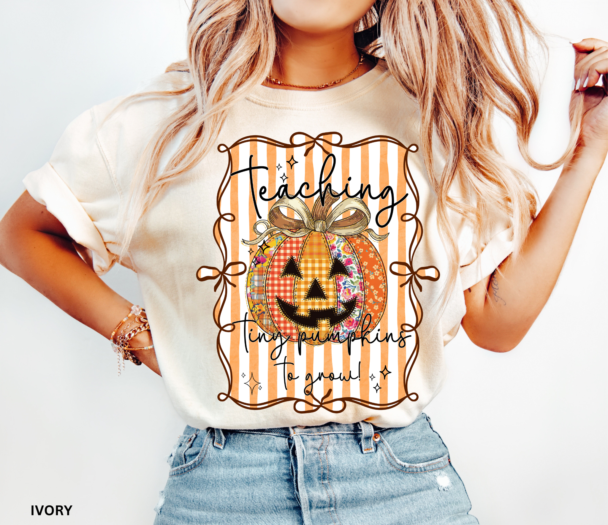 Halloween teacher shirt with an orange patchwork jack-o’-lantern tied in a bow on a striped background and the phrase “Teaching Tiny Pumpkins to Grow.”