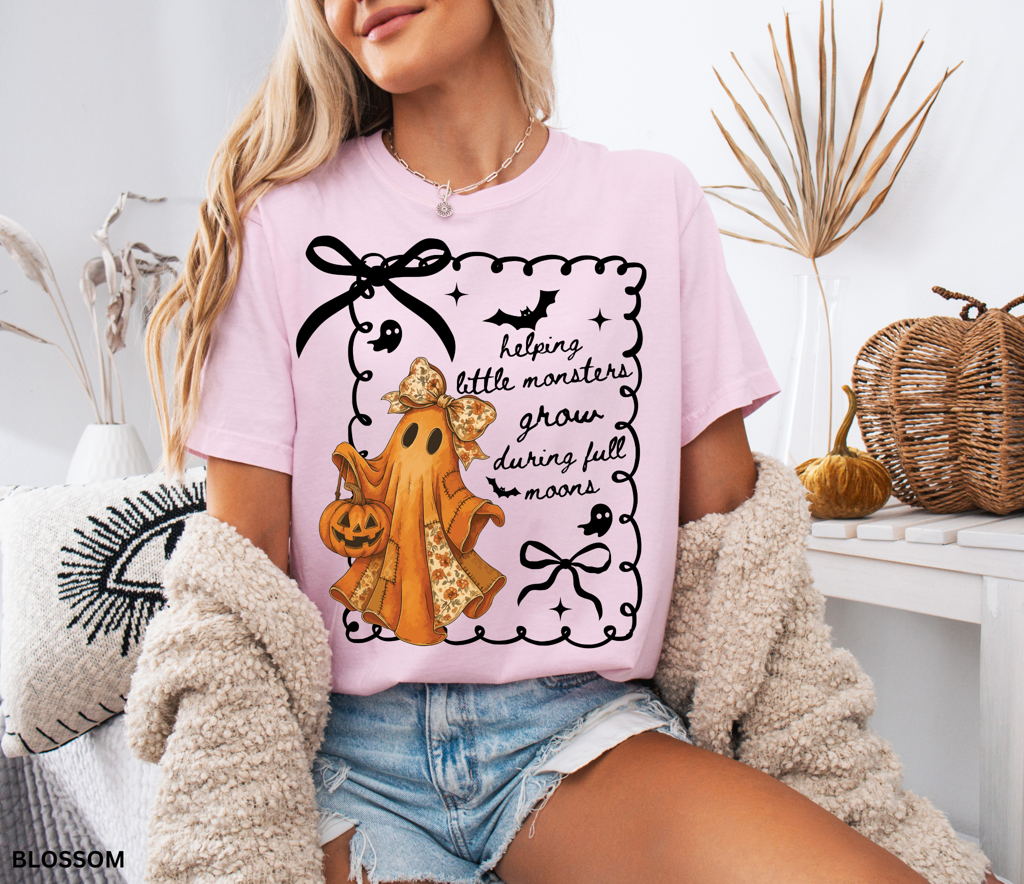 Halloween daycare teacher shirt with an orange patchwork ghost wearing a floral bow, holding a jack-o’-lantern pumpkin bucket.