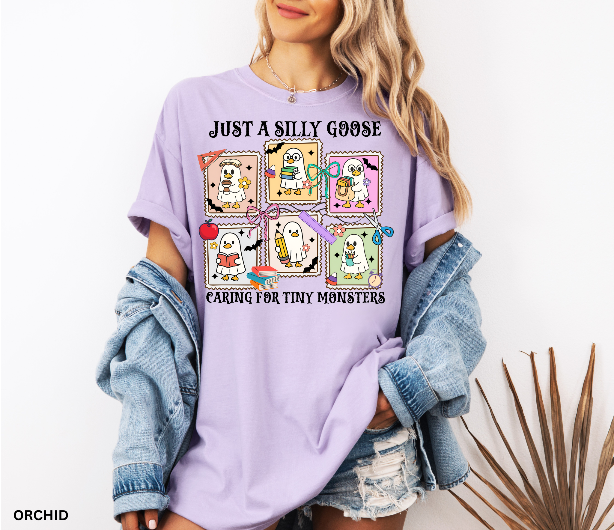 Halloween daycare teacher shirt featuring six cartoon geese in ghost costumes holding books, pencils, and coffee with the phrase “Just a Silly Goose Caring for Tiny Monsters.”