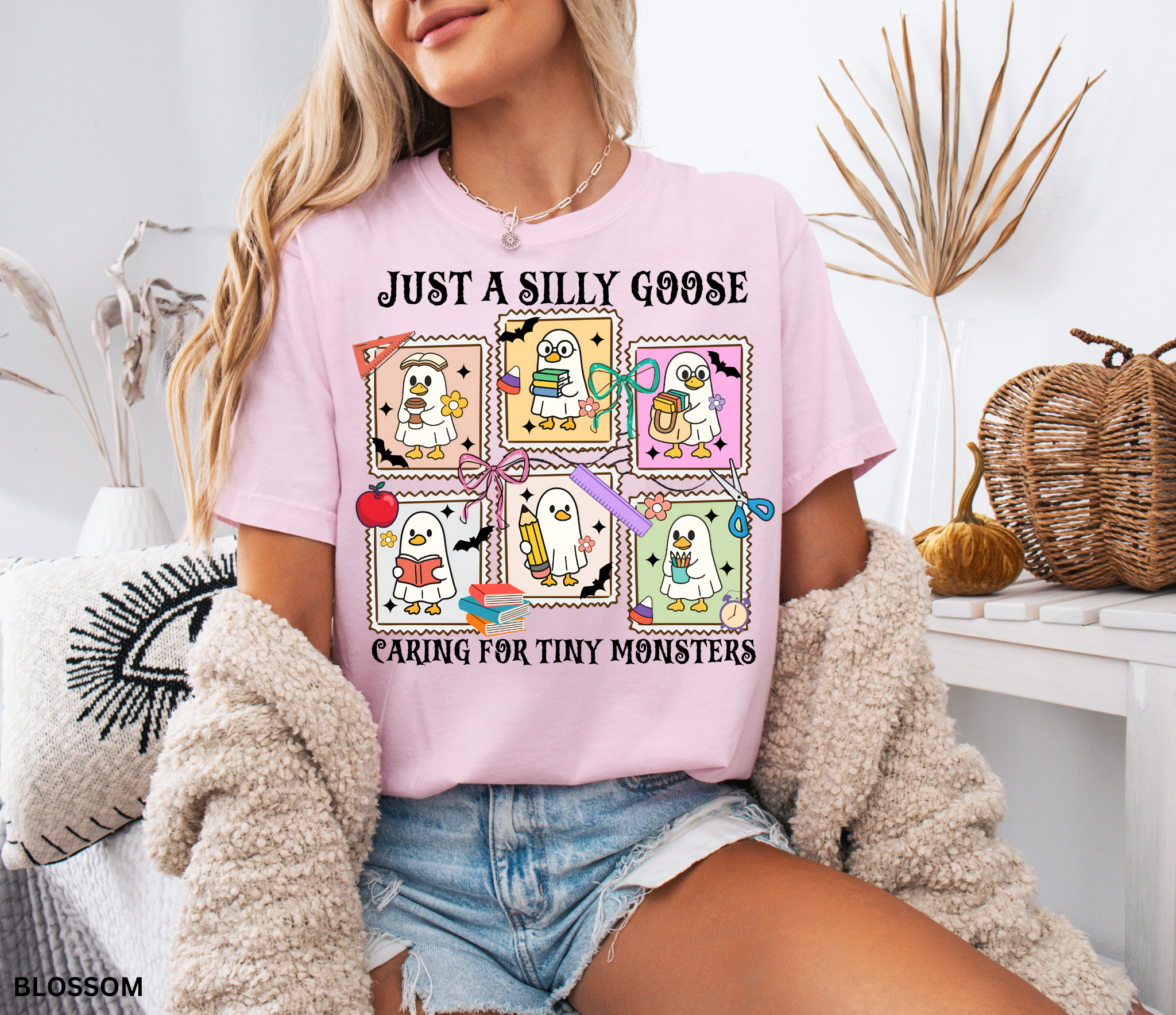 Halloween daycare teacher shirt featuring six cartoon geese in ghost costumes holding books, pencils, and coffee with the phrase “Just a Silly Goose Caring for Tiny Monsters.”
