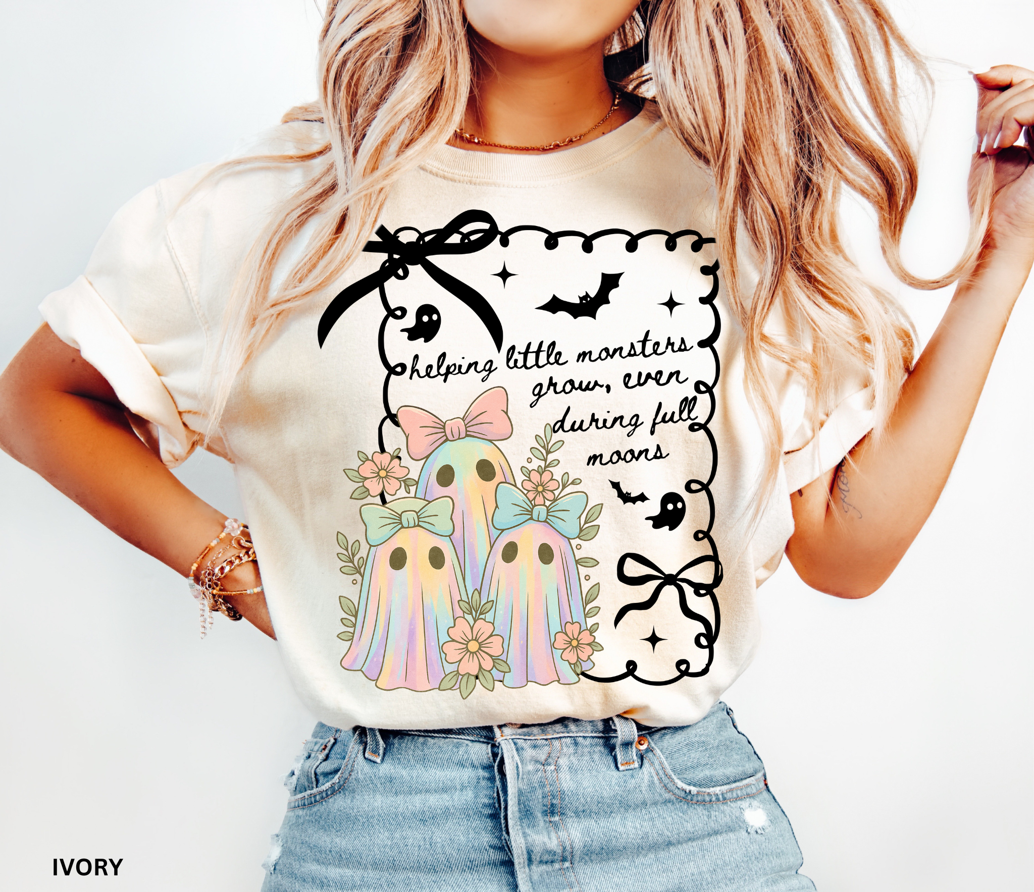 Daycare teacher Halloween shirt with three pastel rainbow ghosts wearing bows, surrounded by flowers, in a spooky-cute design.