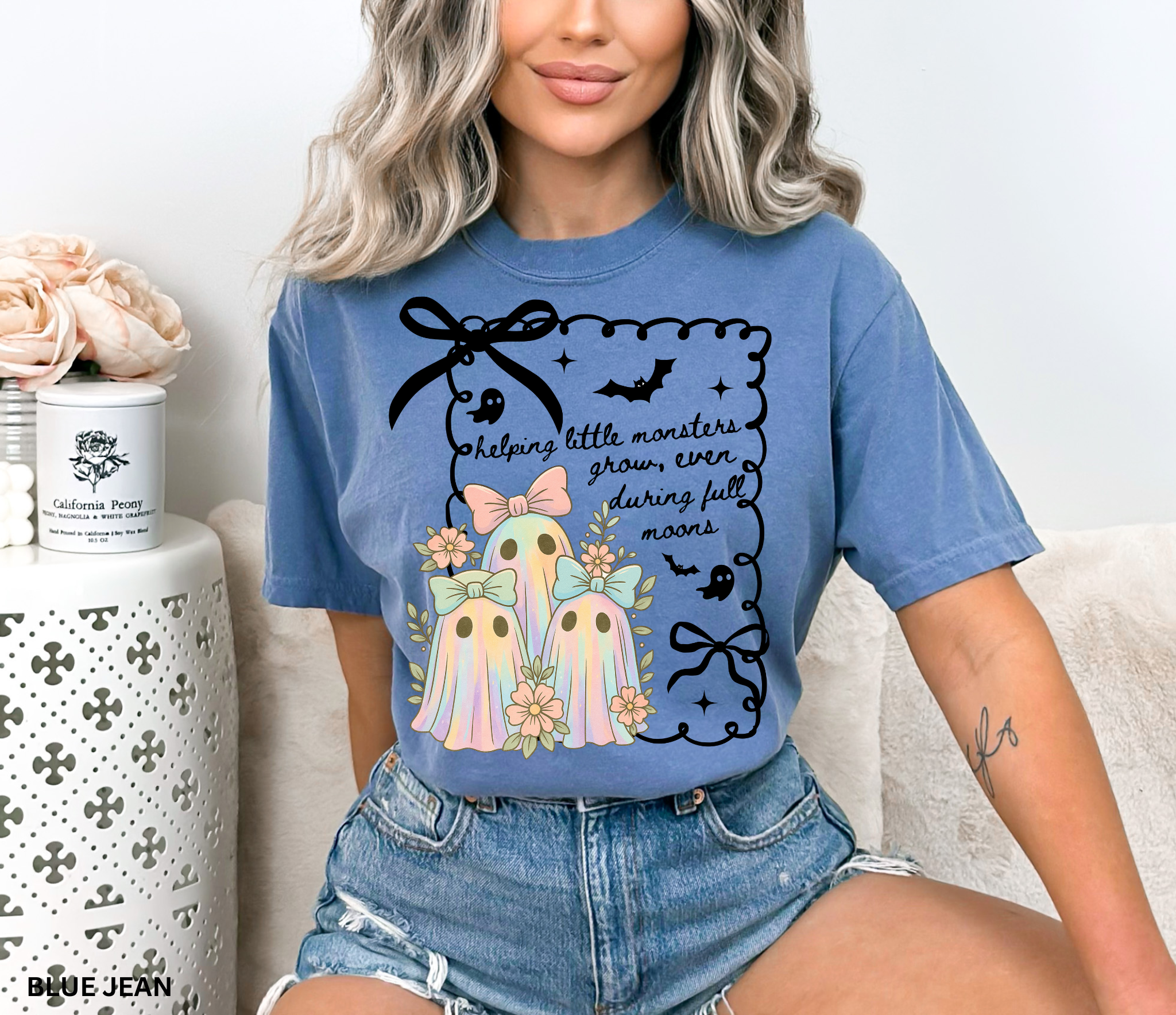 Daycare teacher Halloween shirt with three pastel rainbow ghosts wearing bows, surrounded by flowers, in a spooky-cute design.
