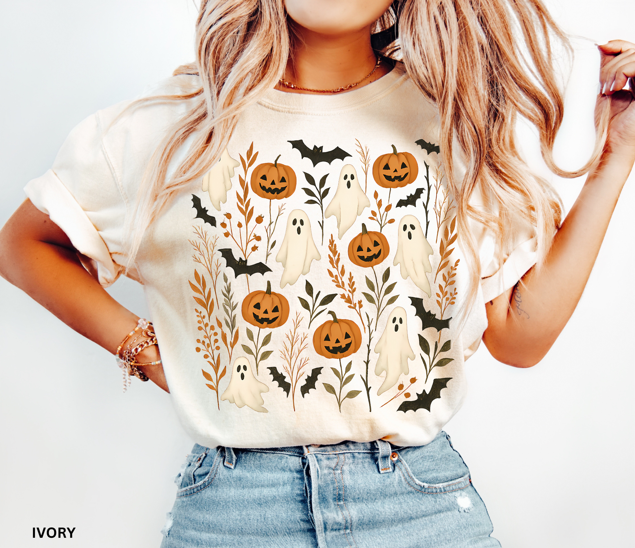 Halloween shirt featuring floating white ghosts, carved pumpkins, bats, and autumn leaves in a whimsical cottagecore design.