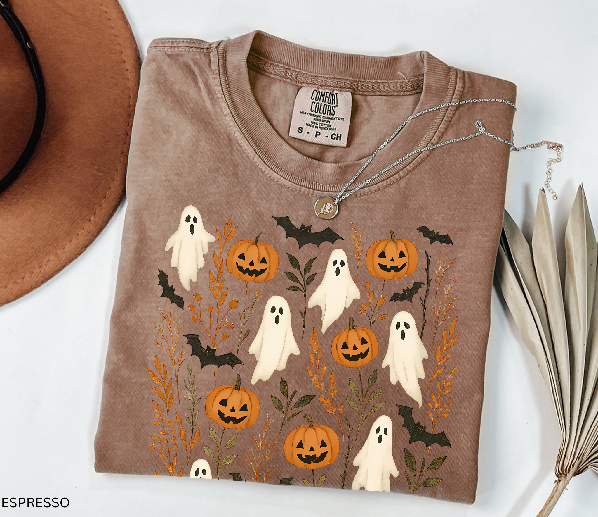 Halloween shirt featuring floating white ghosts, carved pumpkins, bats, and autumn leaves in a whimsical cottagecore design.