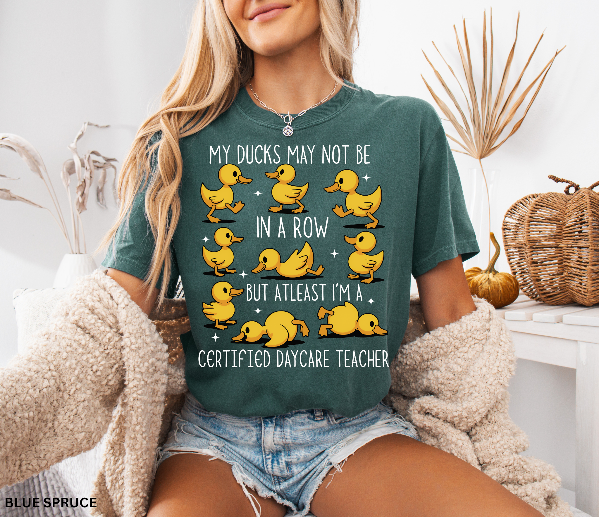 Funny daycare teacher shirt with cartoon yellow ducks in different poses and the phrase “My Ducks May Not Be in a Row but at Least I’m a Certified Daycare Teacher.”