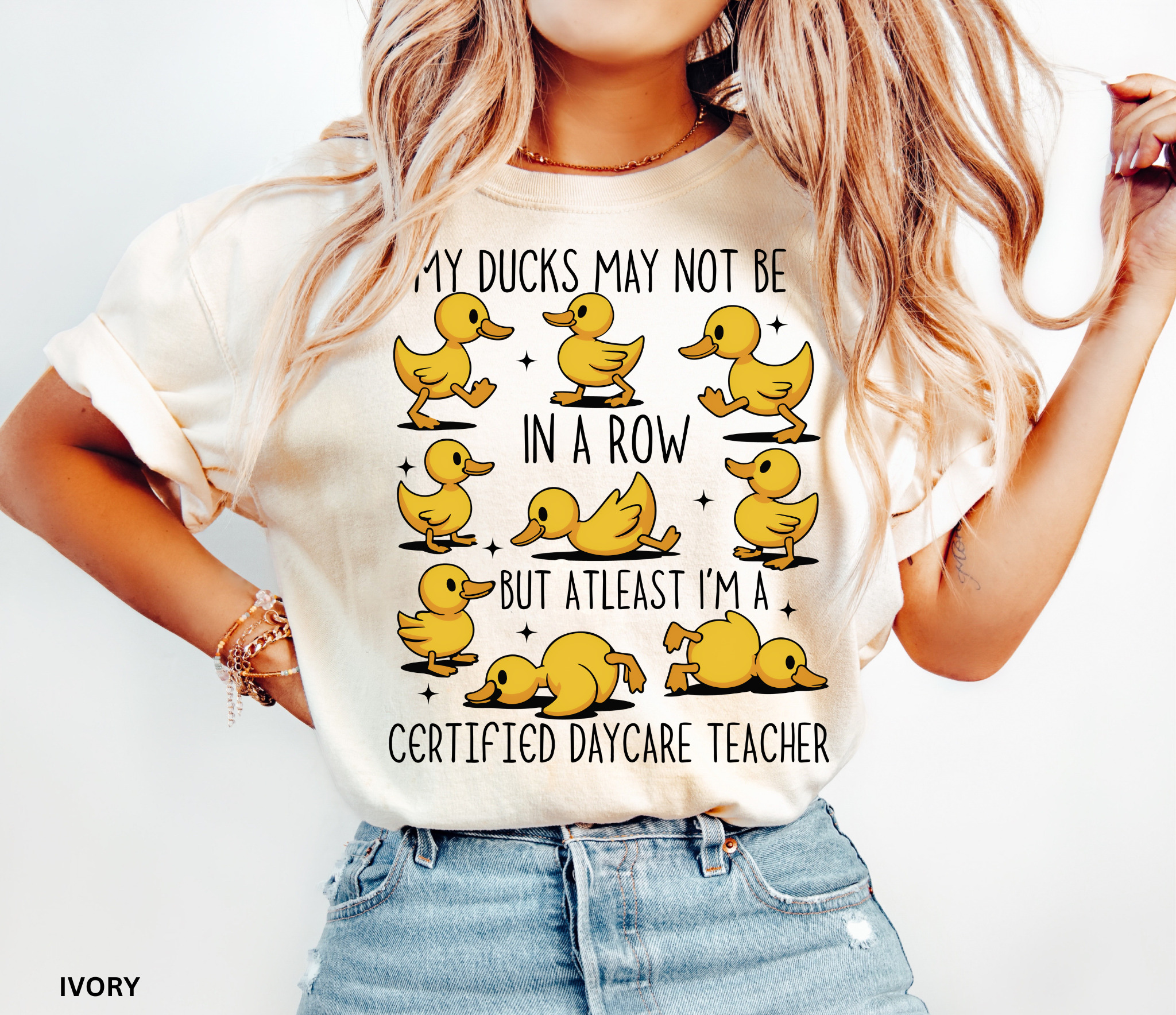 Funny daycare teacher shirt with cartoon yellow ducks in different poses and the phrase “My Ducks May Not Be in a Row but at Least I’m a Certified Daycare Teacher.”