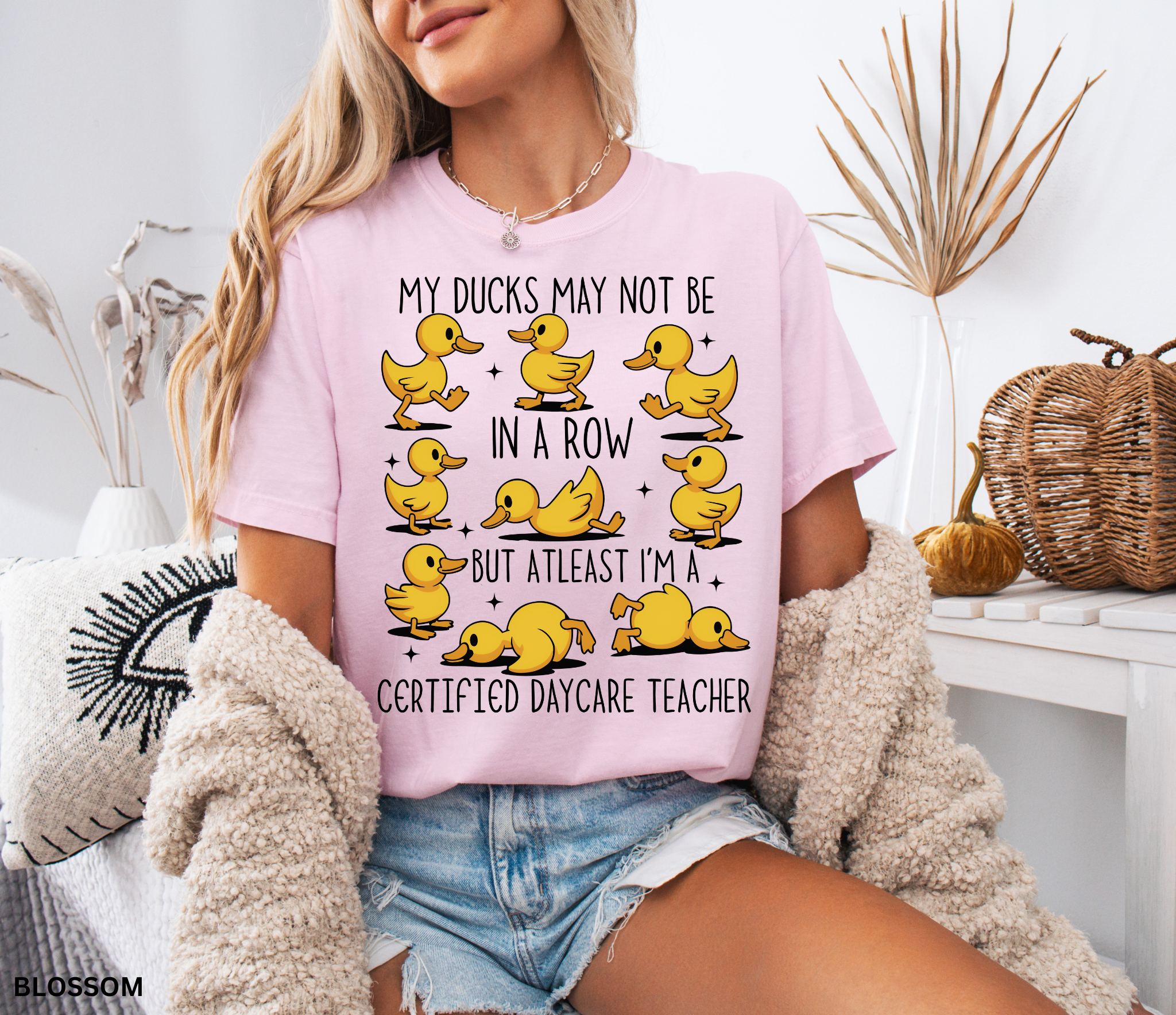 Funny daycare teacher shirt with cartoon yellow ducks in different poses and the phrase “My Ducks May Not Be in a Row but at Least I’m a Certified Daycare Teacher.”
