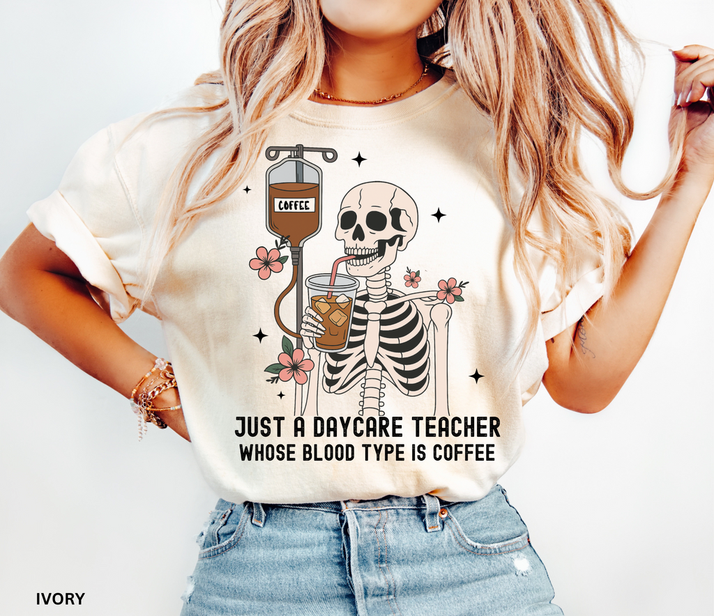 Daycare teacher Halloween shirt with a skeleton sipping iced coffee through a straw connected to an IV bag labeled “coffee,” surrounded by flowers and stars.