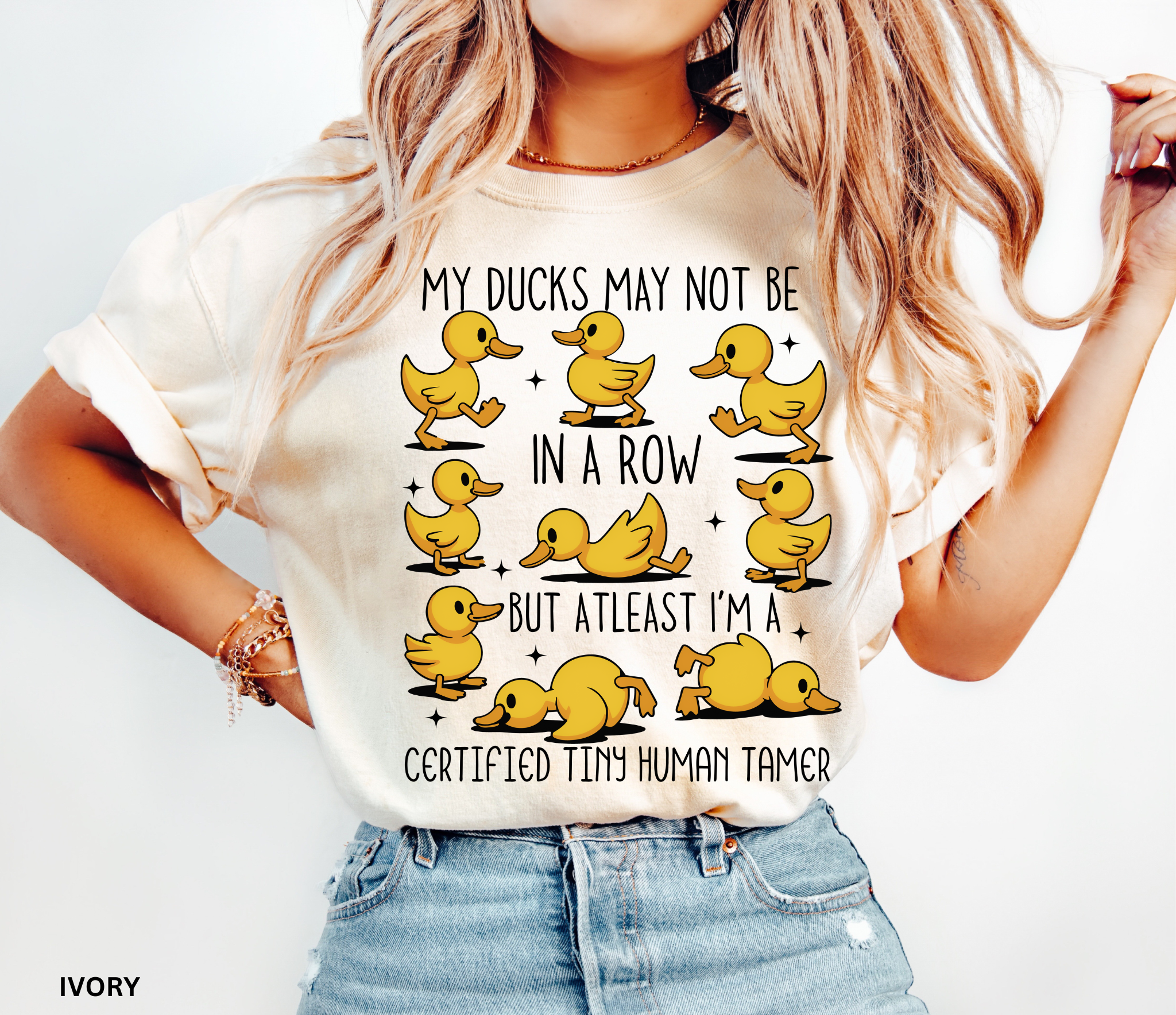 Daycare teacher shirt with nine playful cartoon yellow ducks in different silly poses, representing humor and the chaos of preschool teaching.