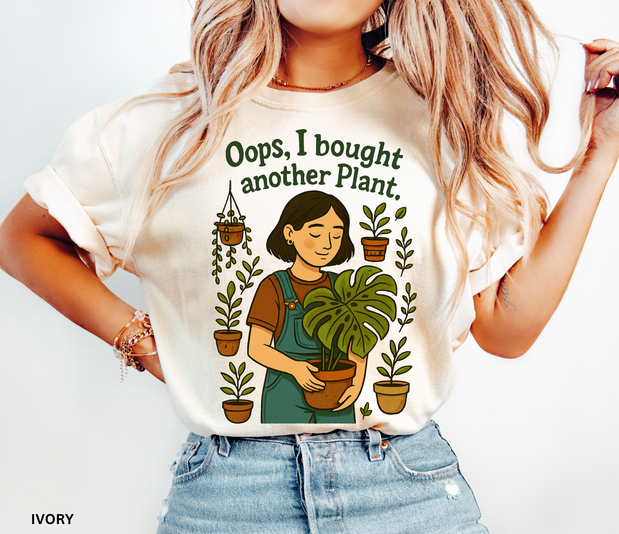 Gardening shirt with a woman in overalls holding a monstera plant, surrounded by potted plants, with the phrase “Oops, I Bought Another Plant.”