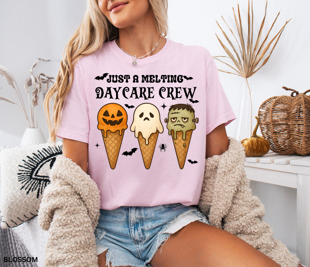 Daycare teacher Halloween shirt with three ice cream cones designed as a pumpkin, ghost, and Frankenstein monster, with the phrase “Just a Melting Daycare Crew.”