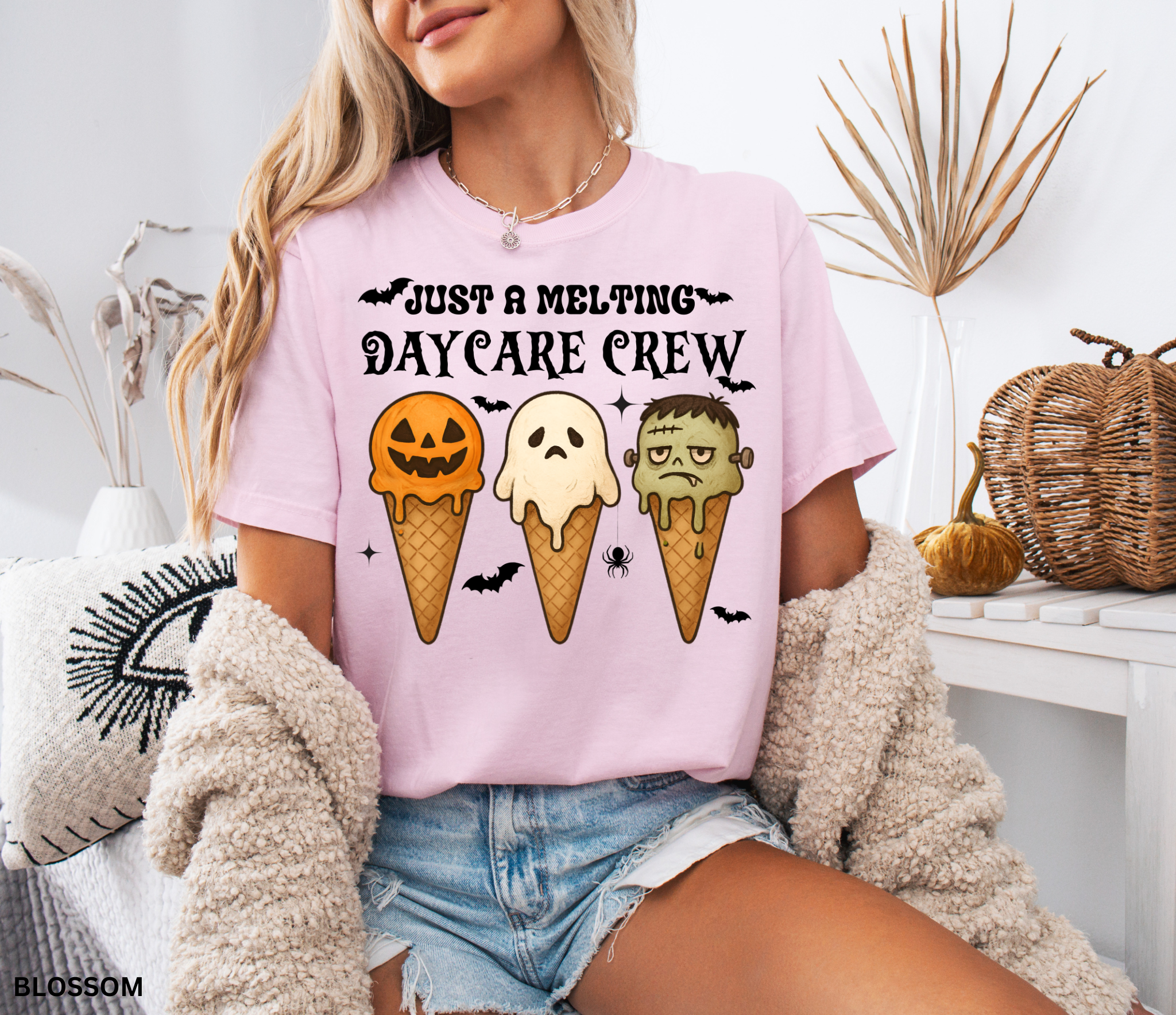 Daycare teacher Halloween shirt with three ice cream cones designed as a pumpkin, ghost, and Frankenstein monster, with the phrase “Just a Melting Daycare Crew.”