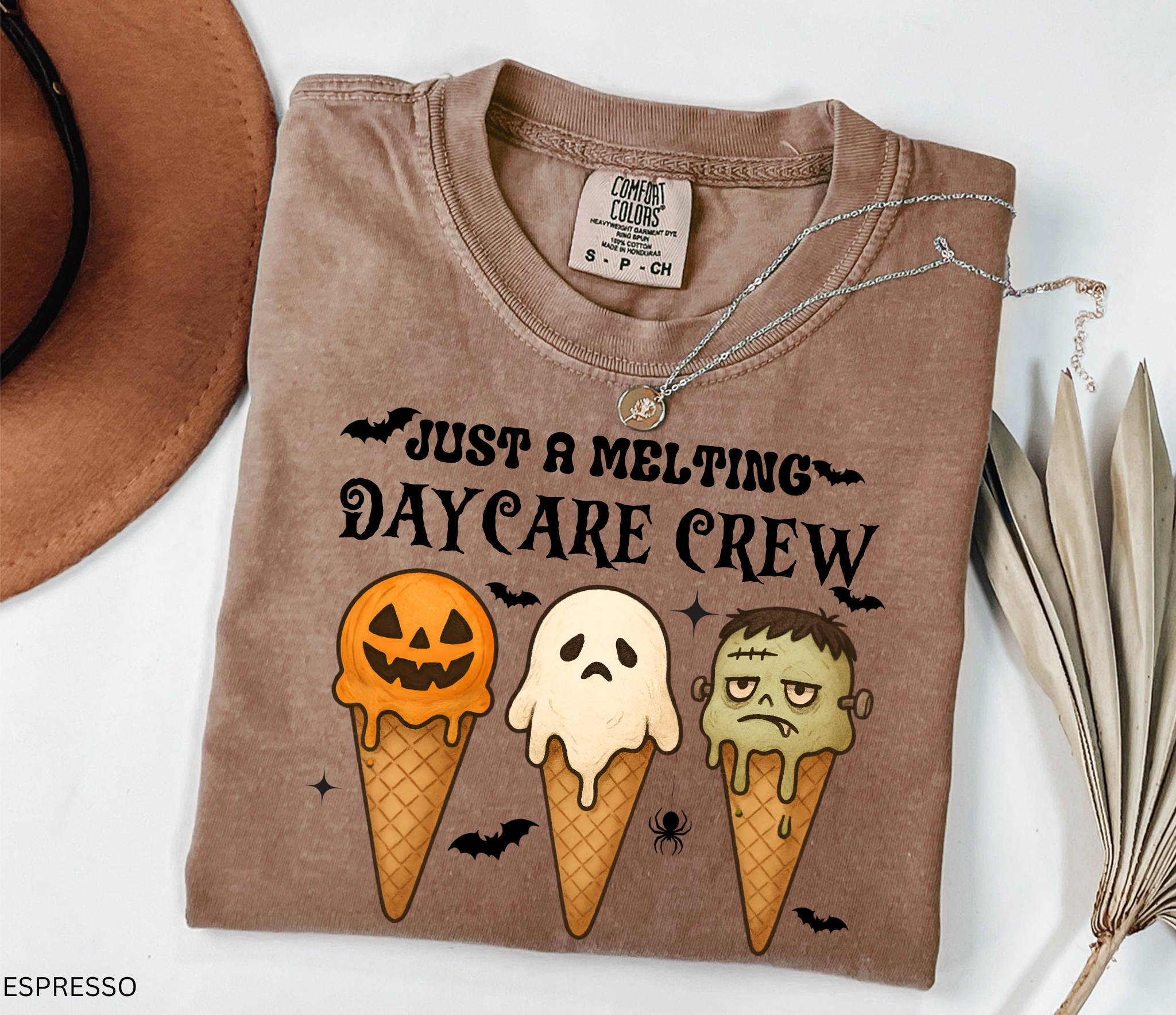 Daycare teacher Halloween shirt with three ice cream cones designed as a pumpkin, ghost, and Frankenstein monster, with the phrase “Just a Melting Daycare Crew.”