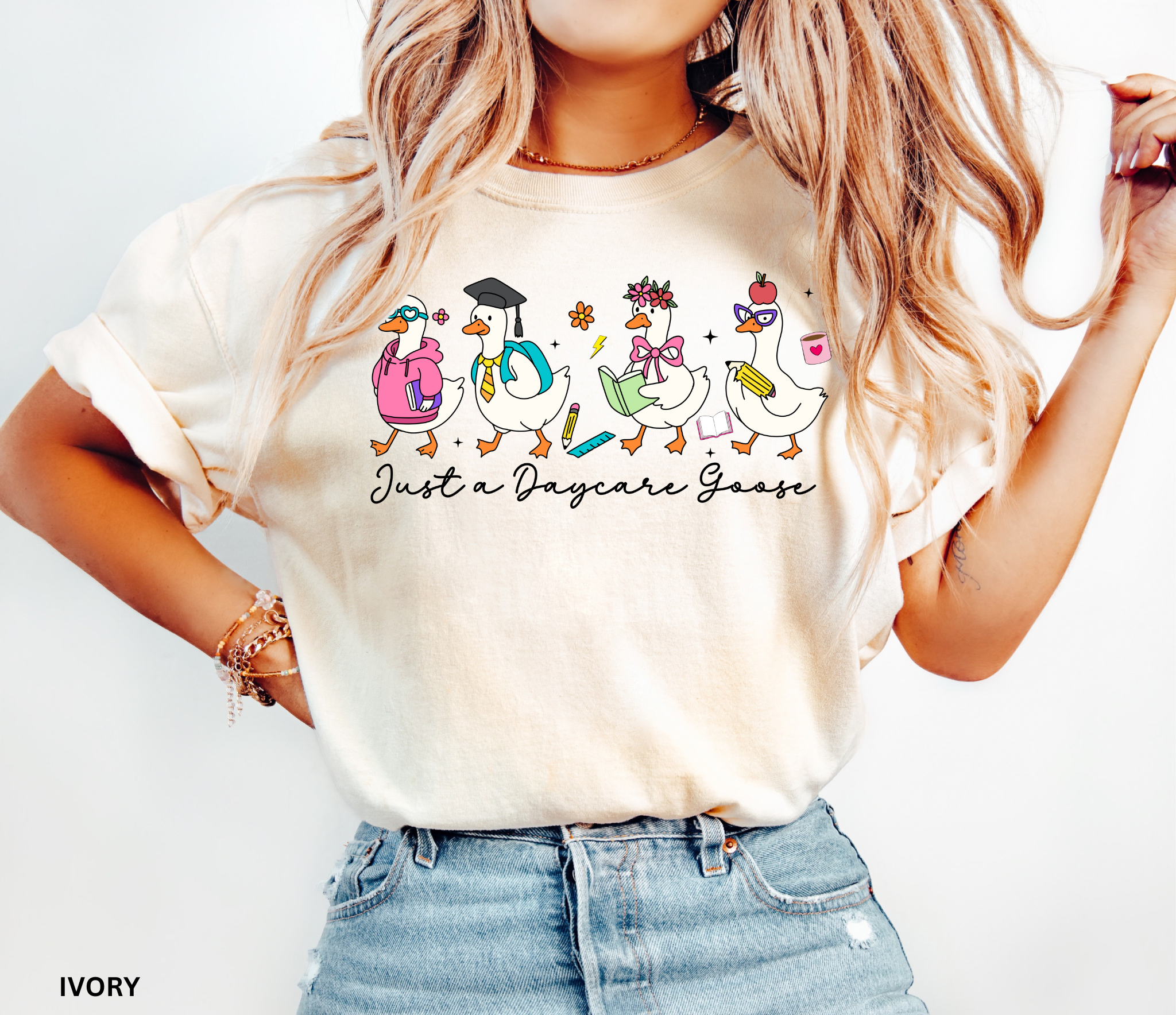 Funny daycare teacher shirt with four cartoon geese dressed as students and teachers, holding books and supplies, with the phrase “Just a Daycare Goose.”