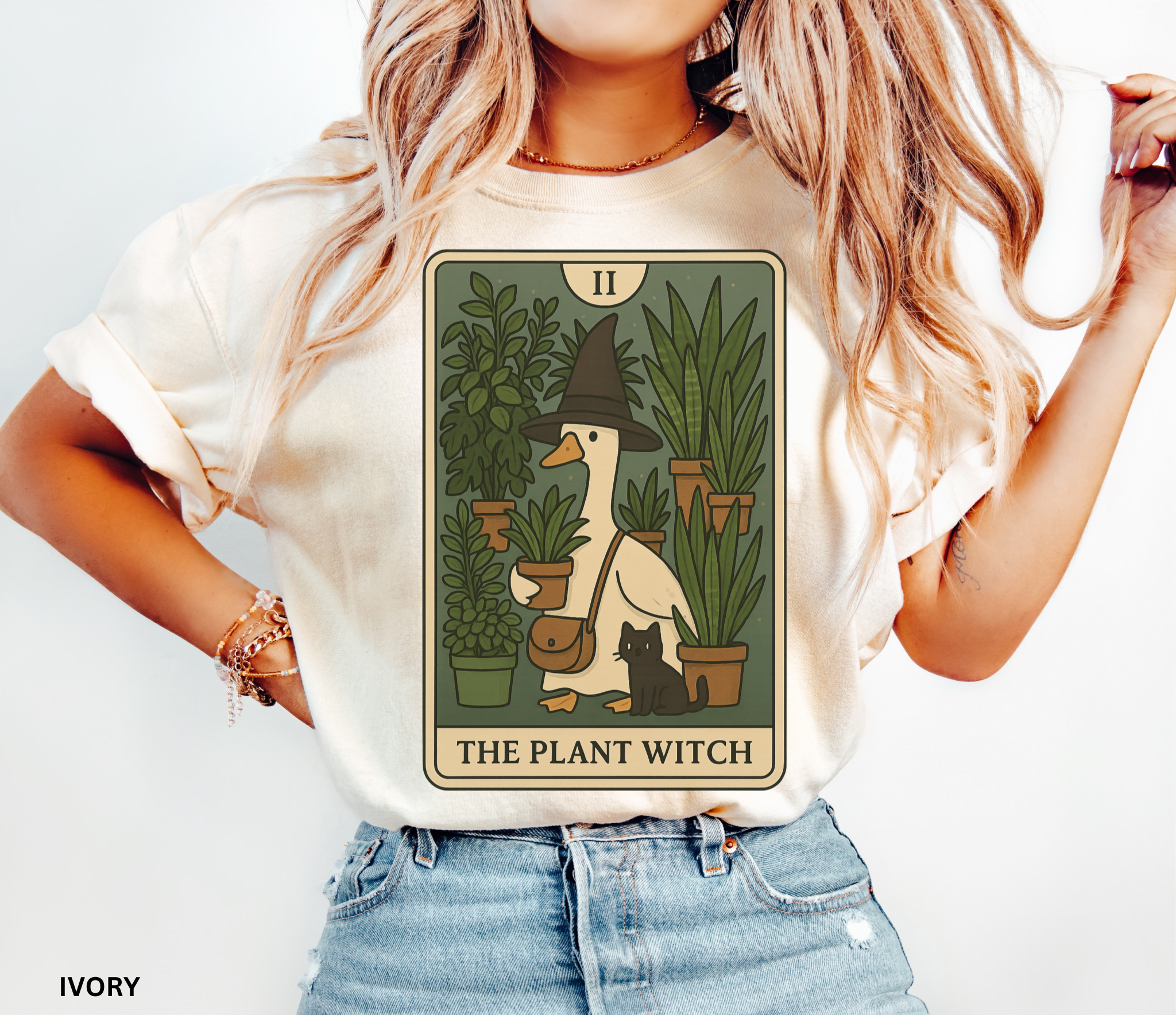 Cartoon goose in a witch hat holding plants with black cat – tarot-style Plant Witch shirt design