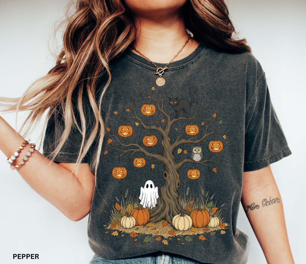 Halloween tree design with jack-o’-lanterns, black cat, ghost, owl, and pumpkins surrounded by autumn leaves – spooky Halloween shirt artwork
