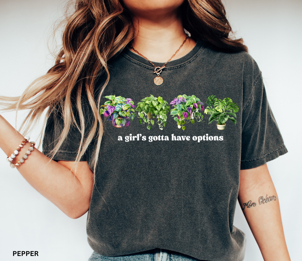 Funny plant shirt with four colorful houseplants and text “a girl’s gotta have options” – gift for plant lovers