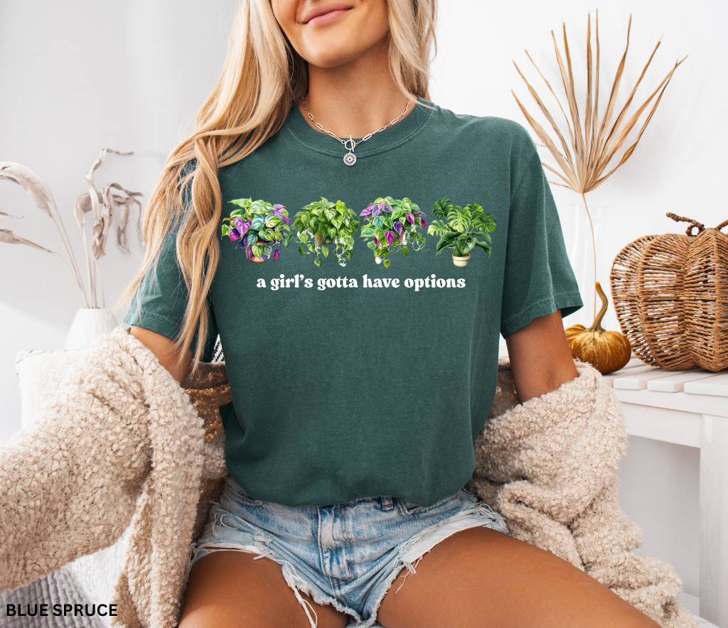 Funny plant shirt with four colorful houseplants and text “a girl’s gotta have options” – gift for plant lovers